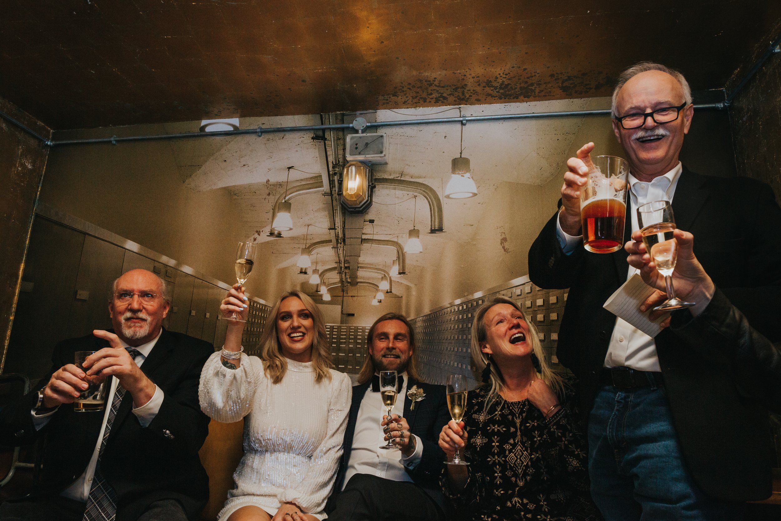 Family raise glasses to step fathers speech. 