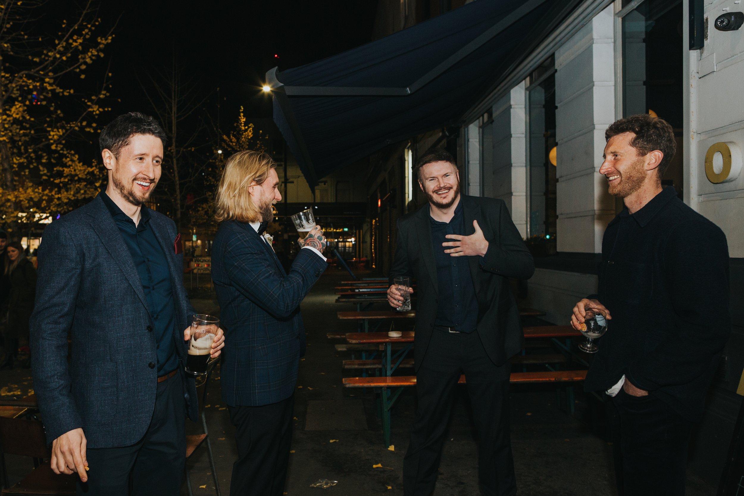 Groom and his groomsmen having a laugh outside the venue. 