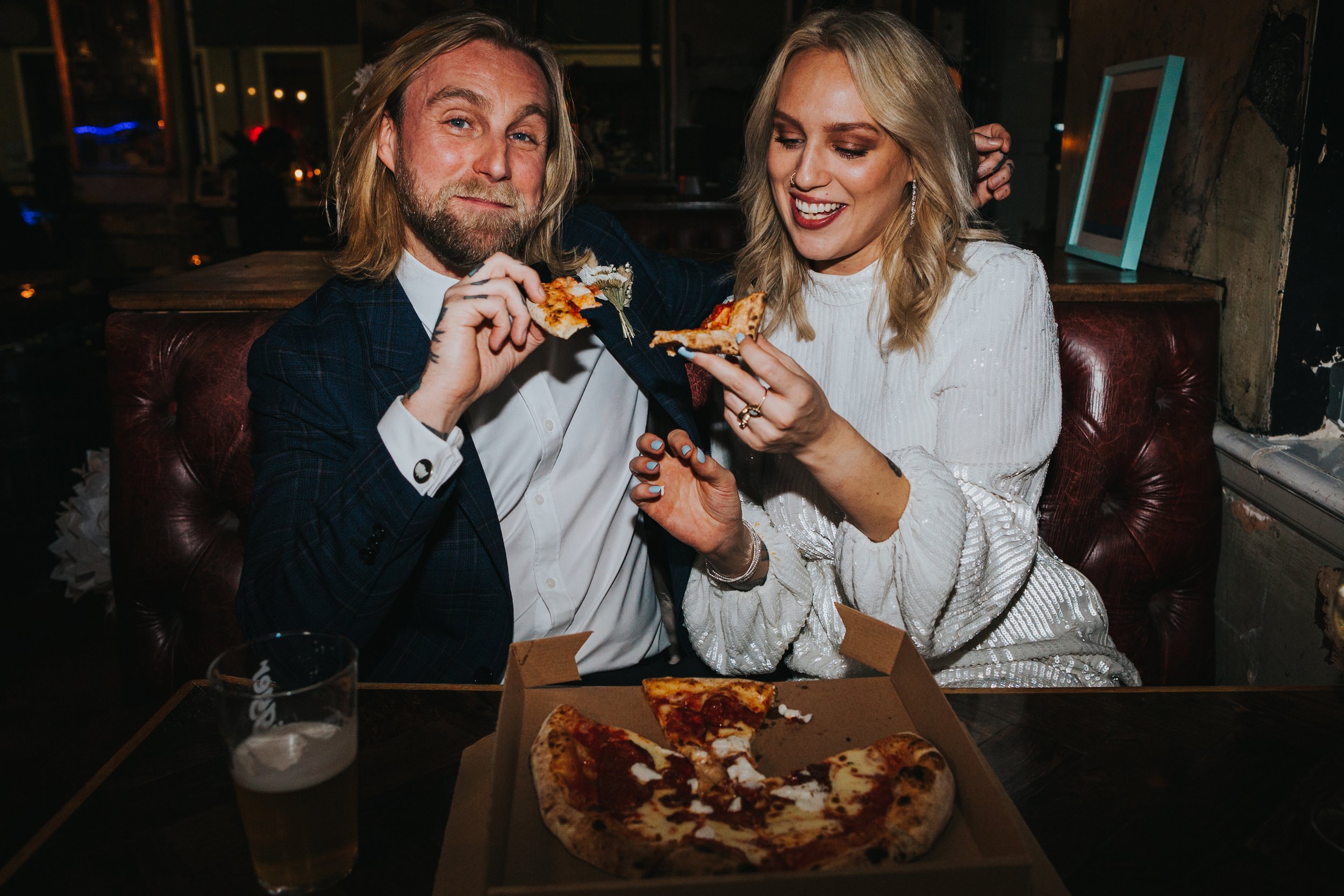 Couple enjoying pizza.