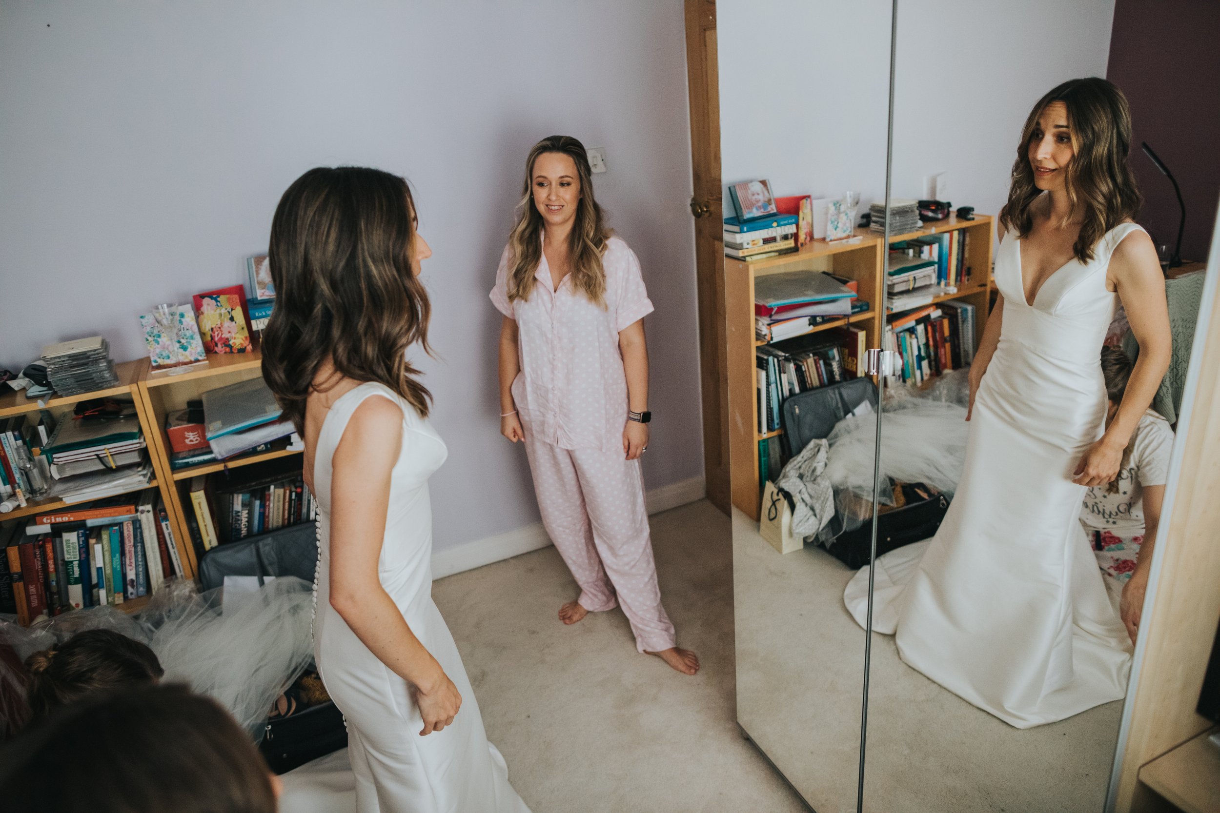 Bride checking herself out in the mirror.