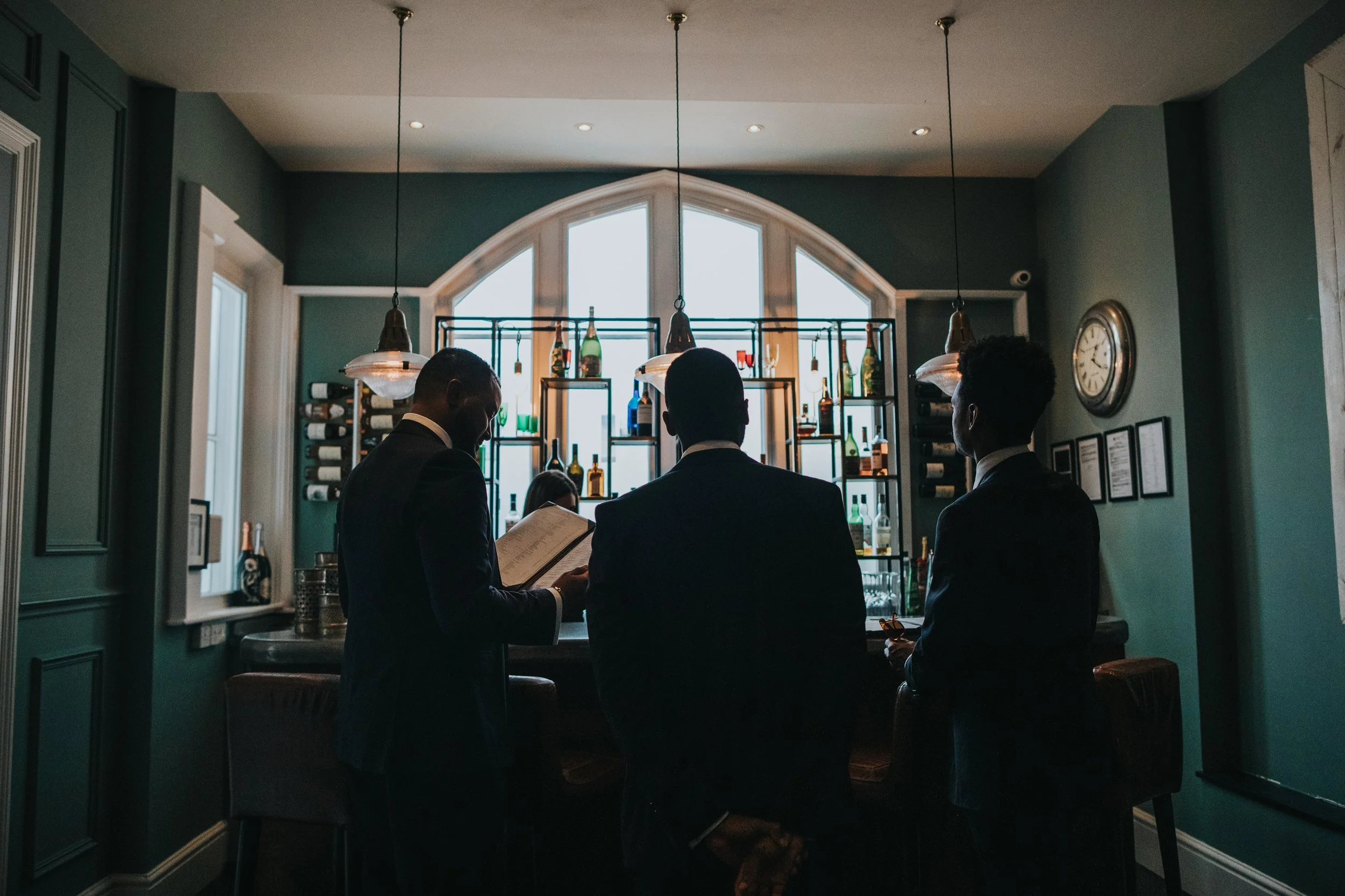 Groom and his groomsmen standing in bar at Didsbury Hotel.