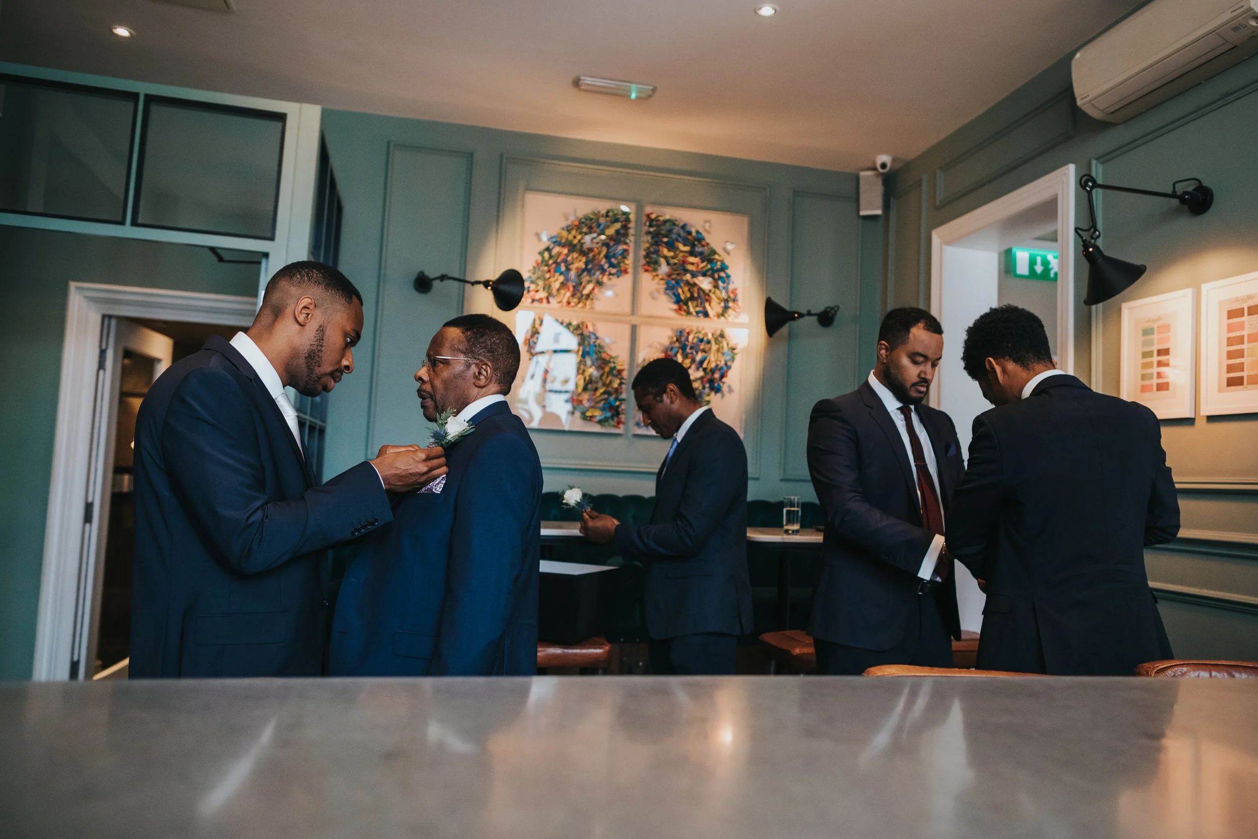 Groomsmen putting on button holes.
