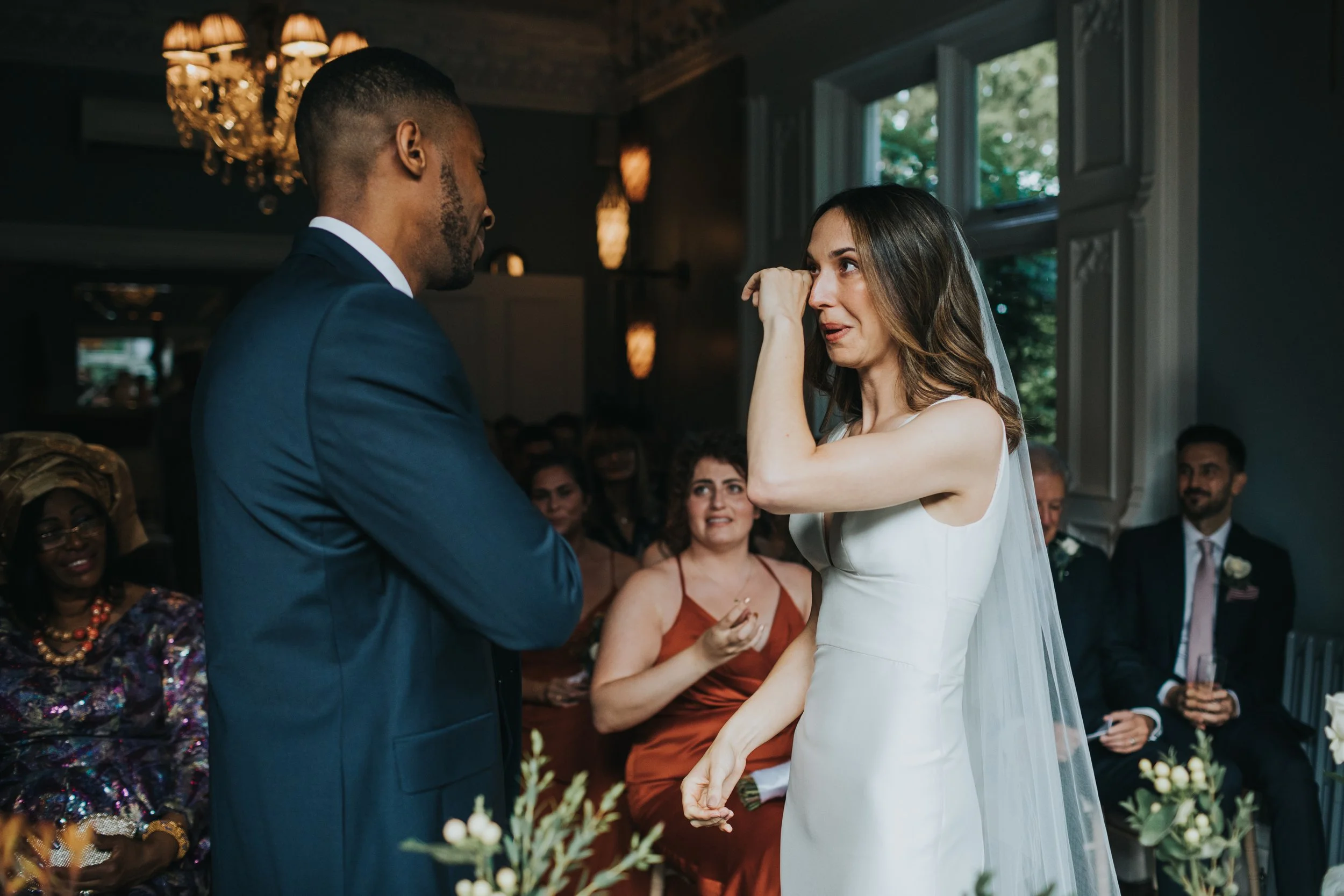 Bride crying as groom says his vows. 