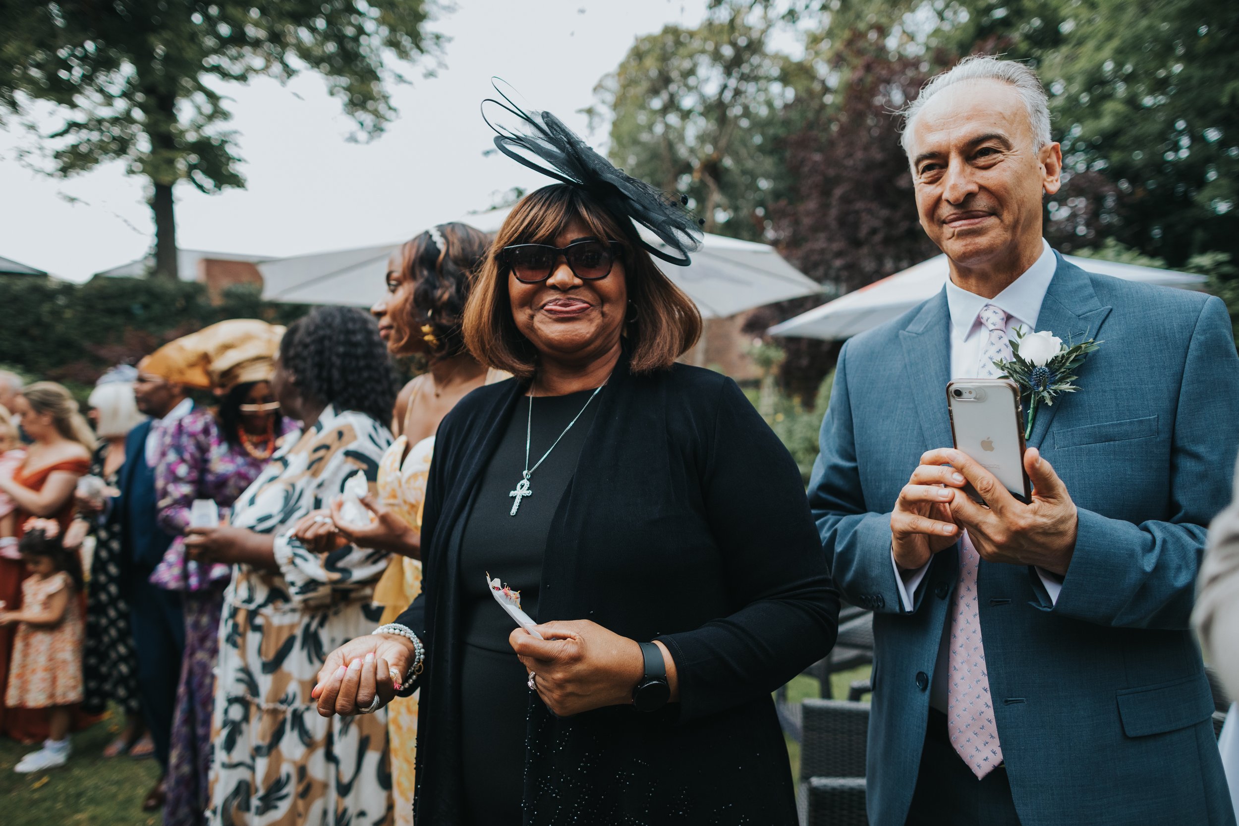 Wedding guest waits with confetti.