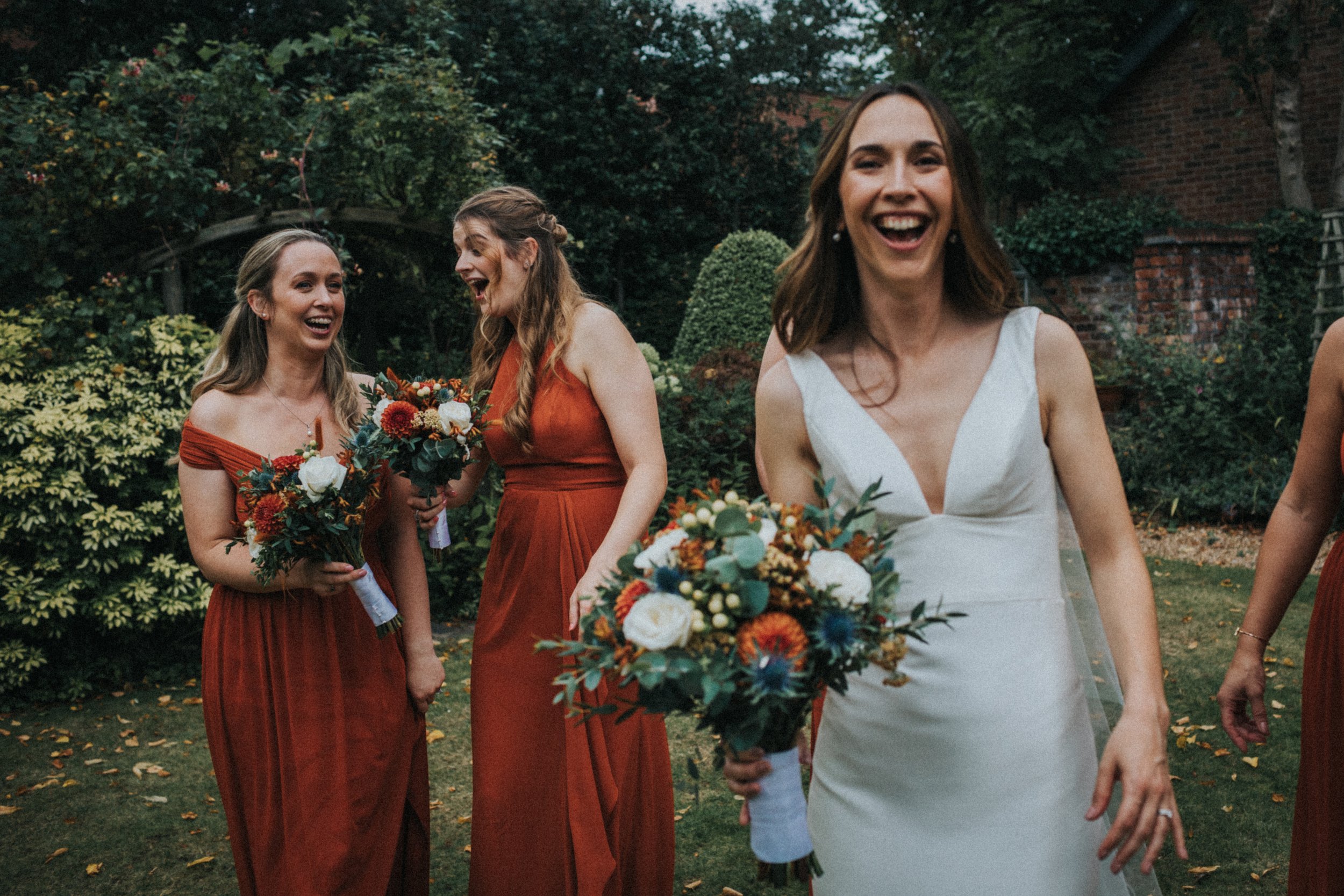 Bride laughs walking towards camera. 