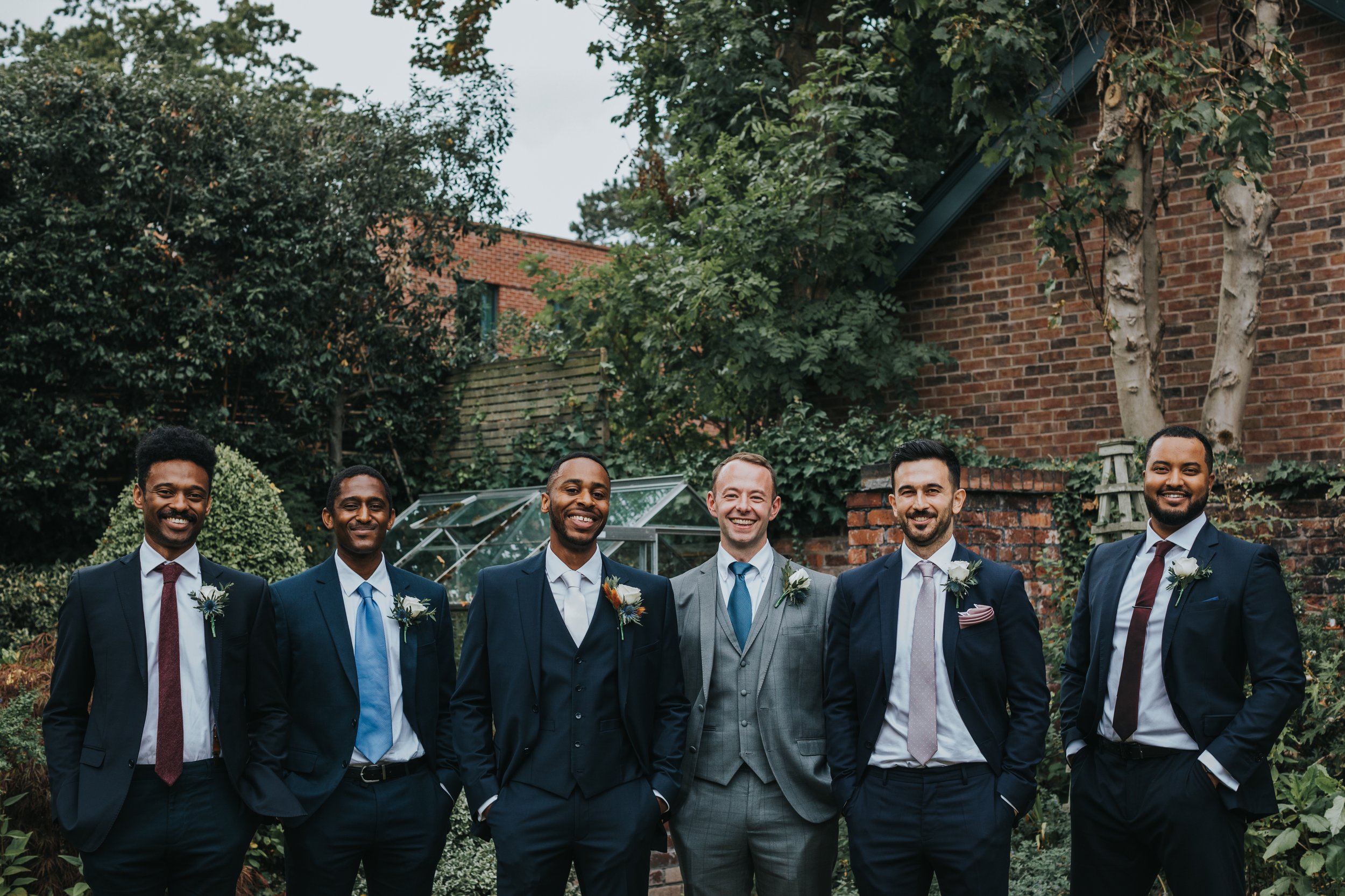 Groomsmen stand together for a photo.