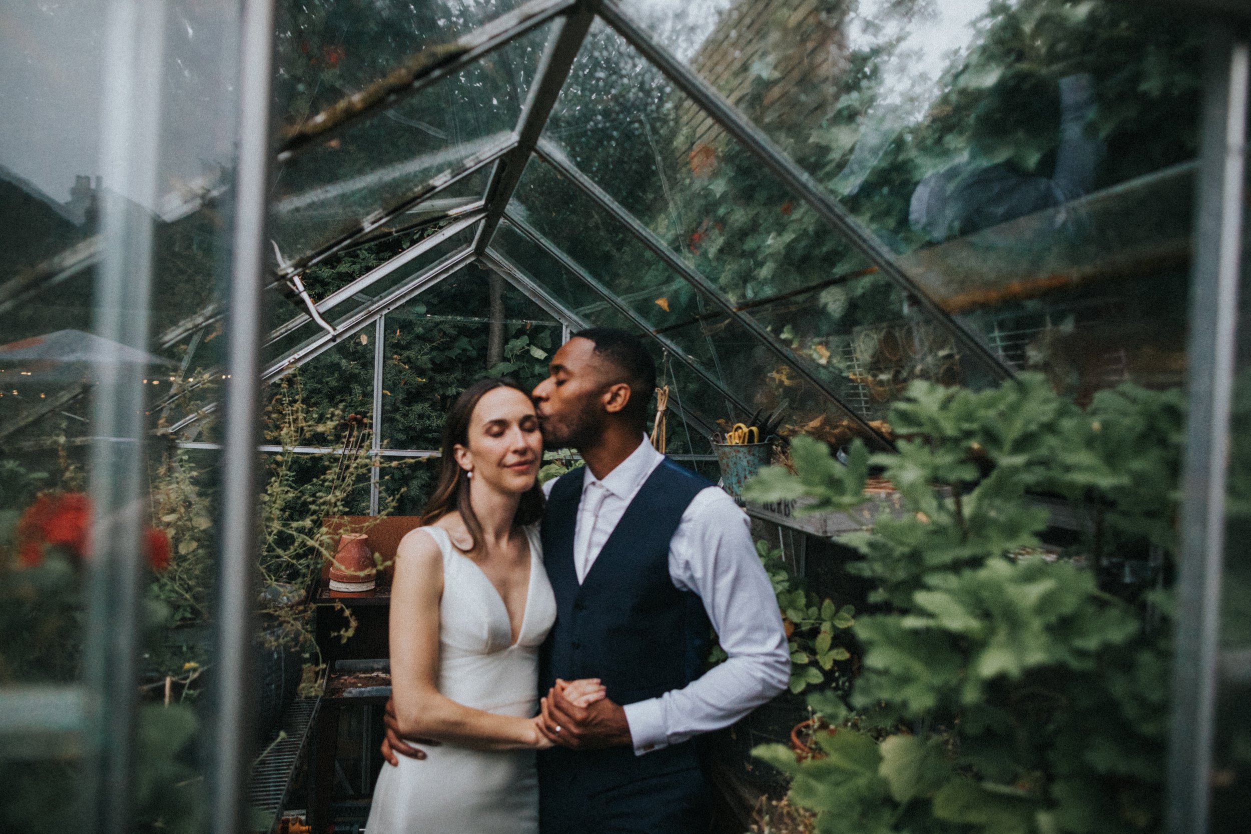 Soft focus photo of Groom kissing his bride. 