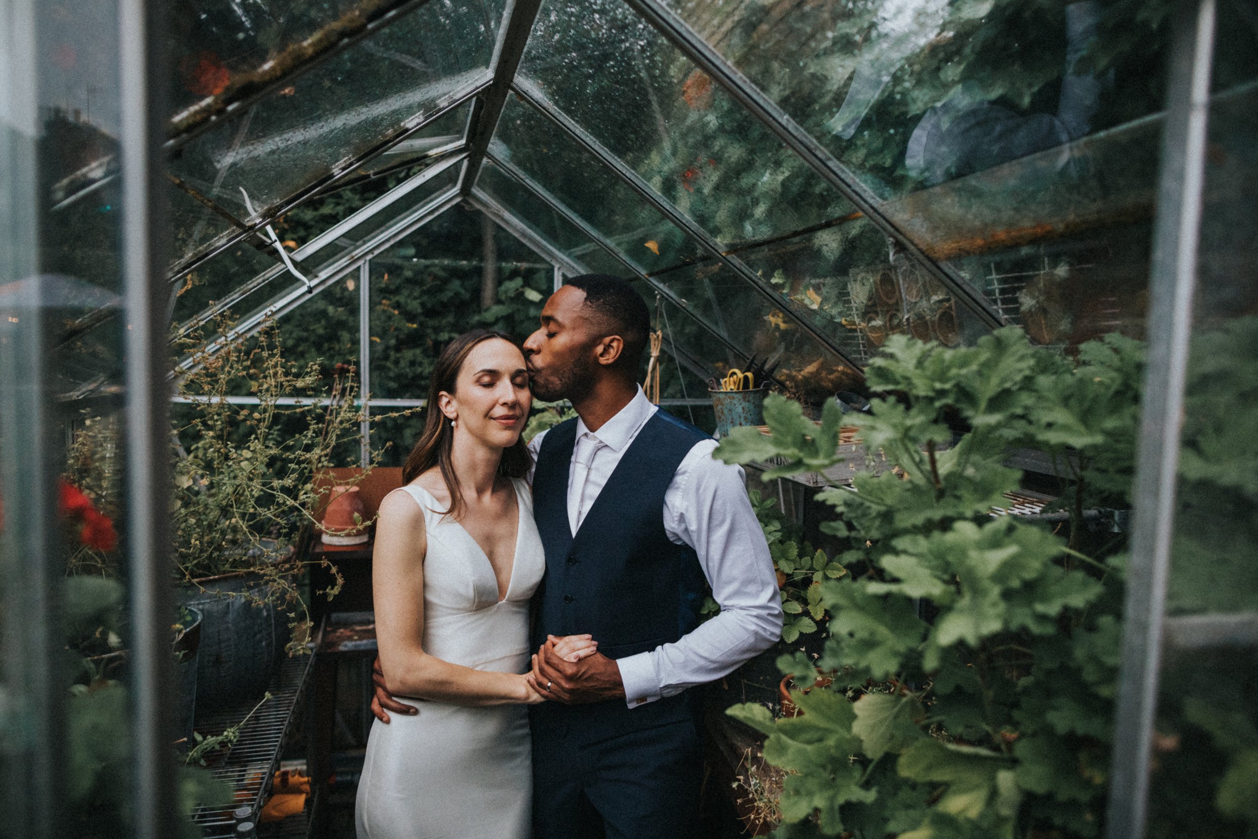 In focus photo of Groom kissing his Bride.