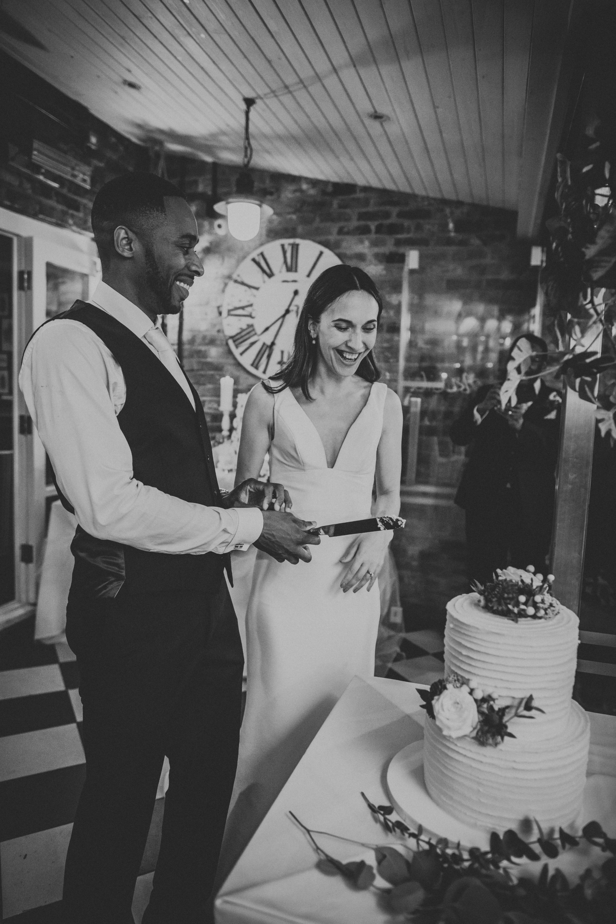 Bride and groom cut wedding cake. 
