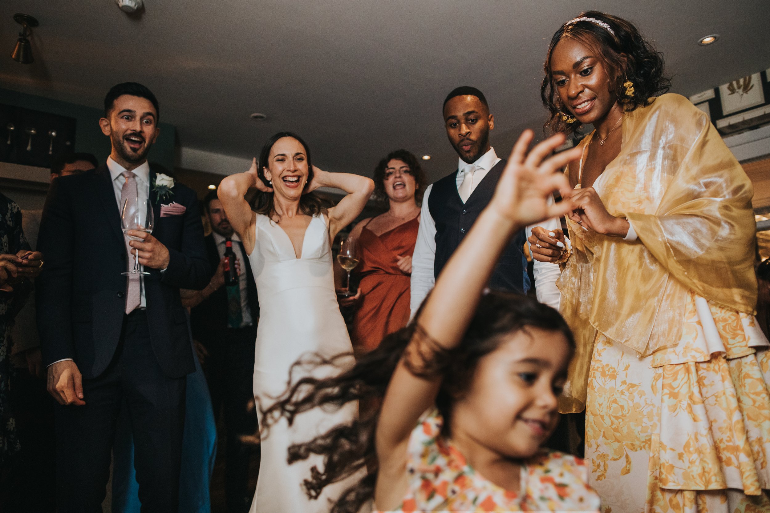 Guests amazed by dancing child. 