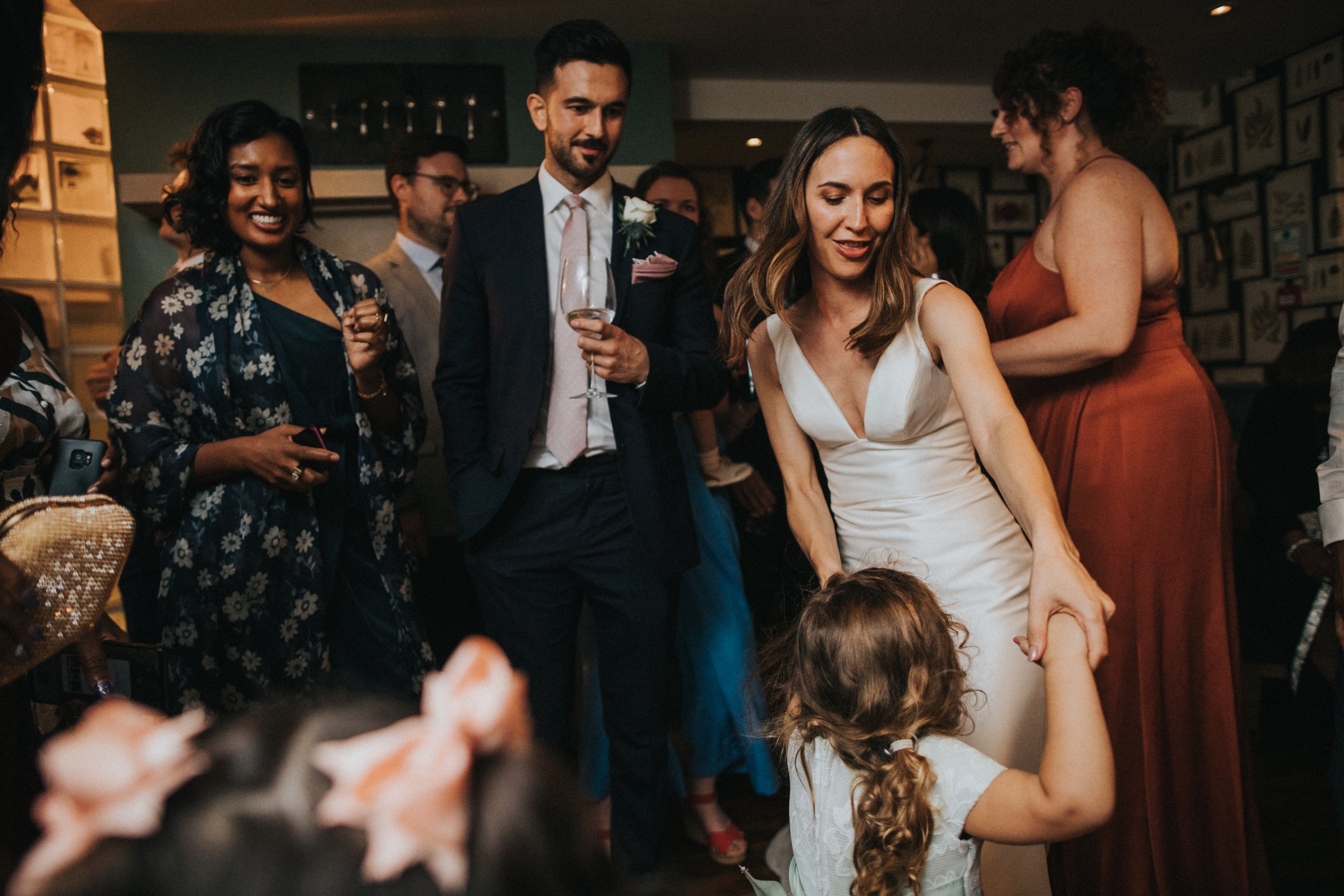 Bride dancing with child. 