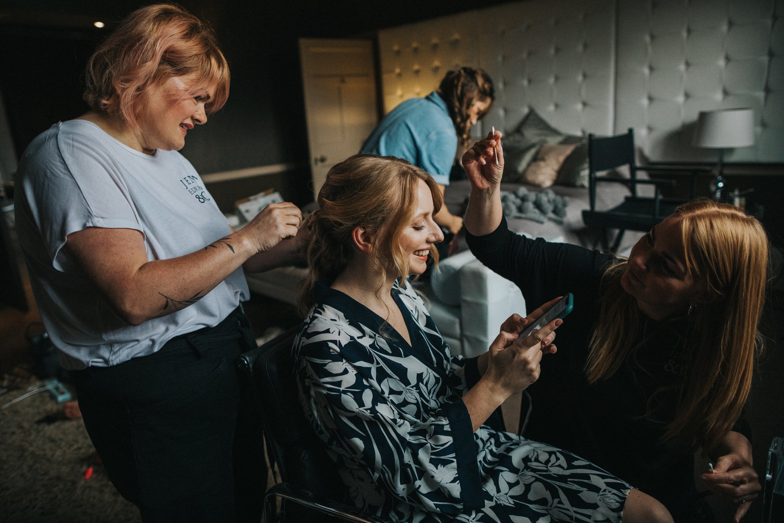 Bride smiles at a text message. 