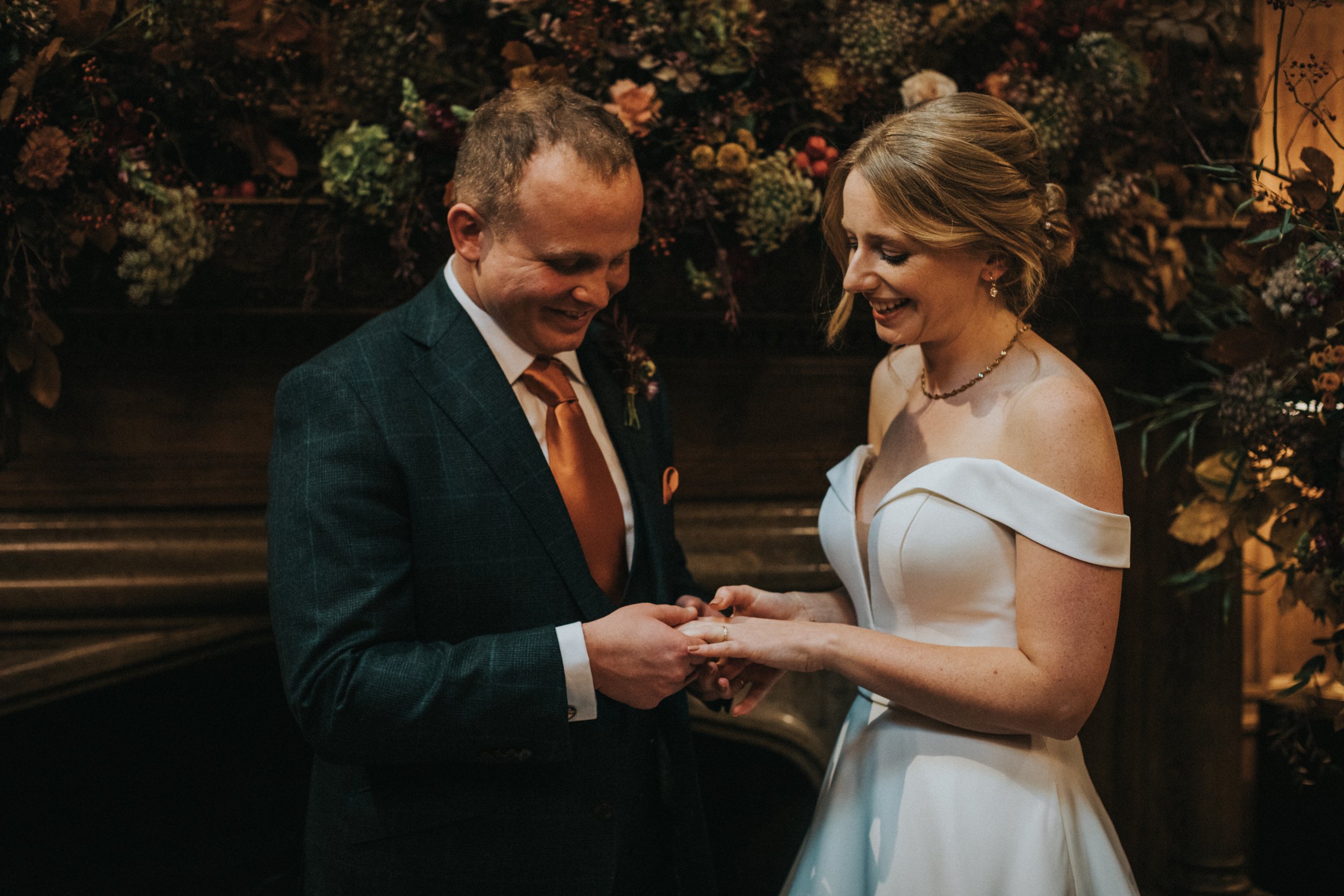 Close up of Bride and Groom looking at their rings