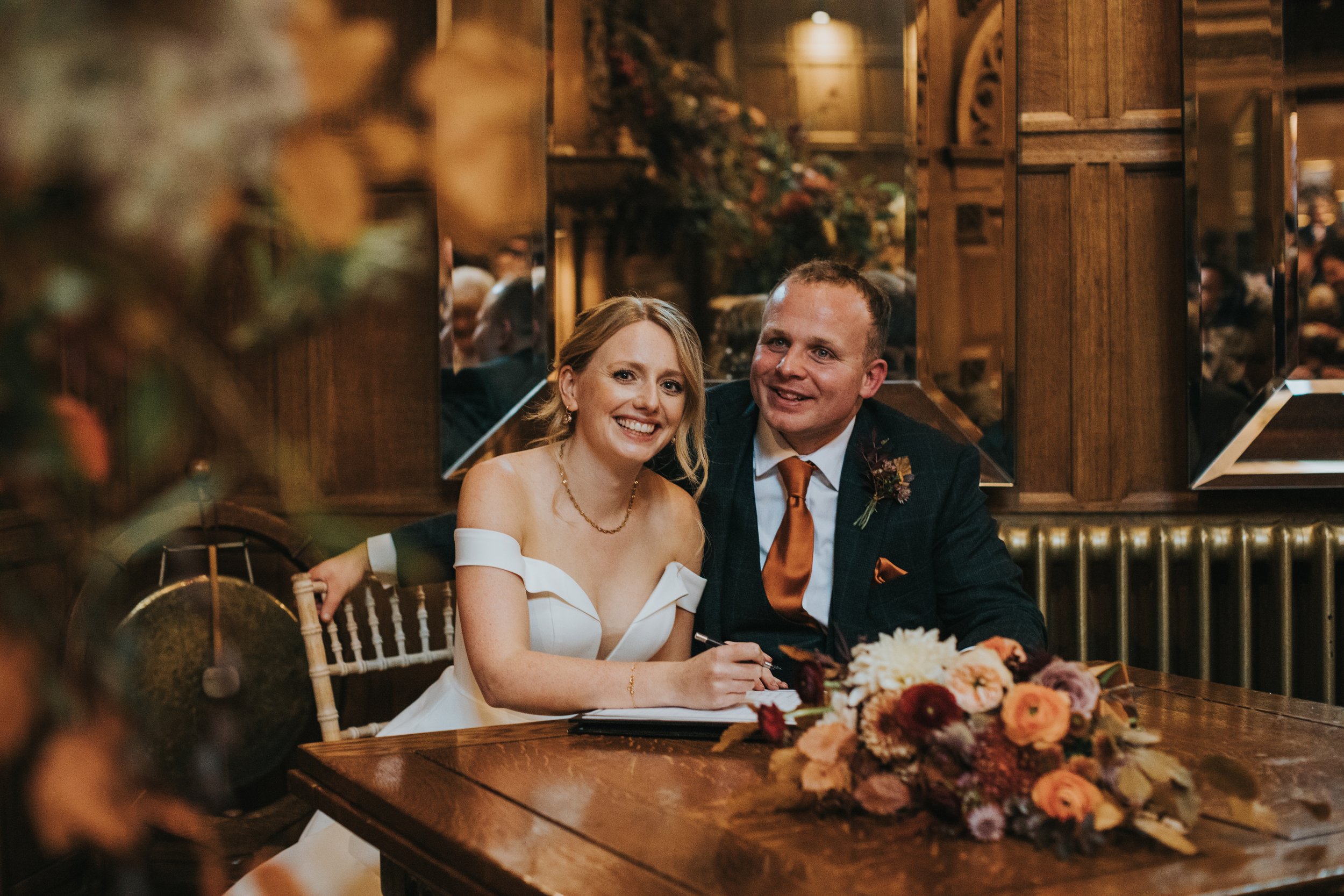 Bride and groom sign the register. 