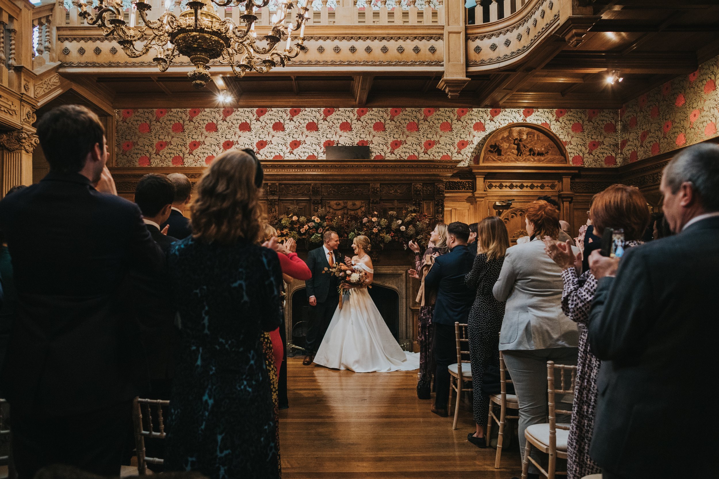 Bride and groom walk down the aisle together.