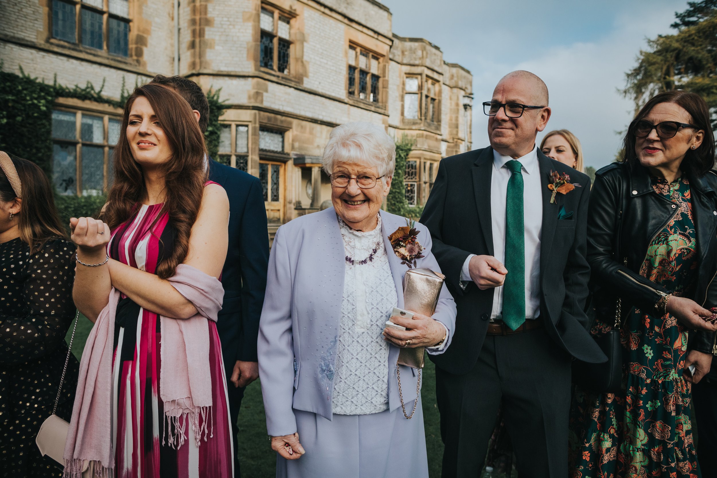 Grandmother of the Groom waits in the confetti line with her confetti. 