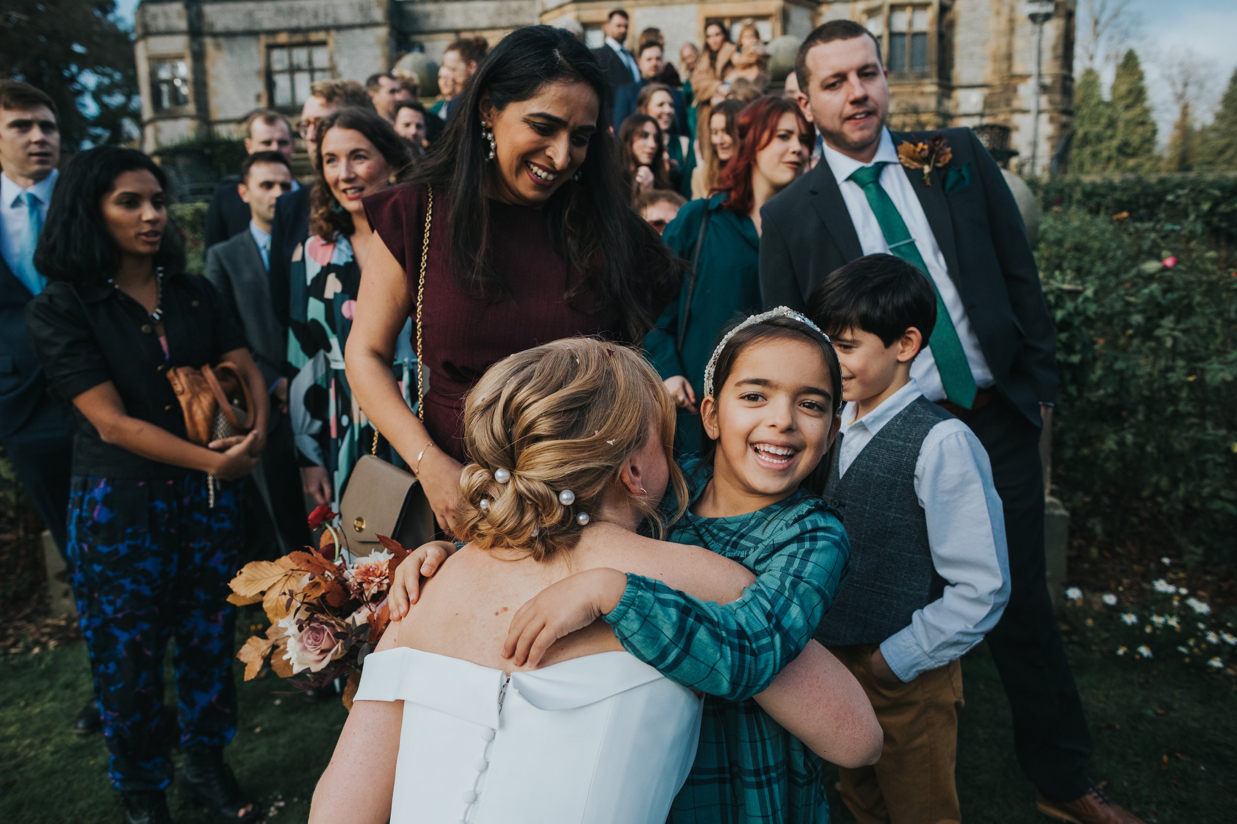 Children hug the bride. 