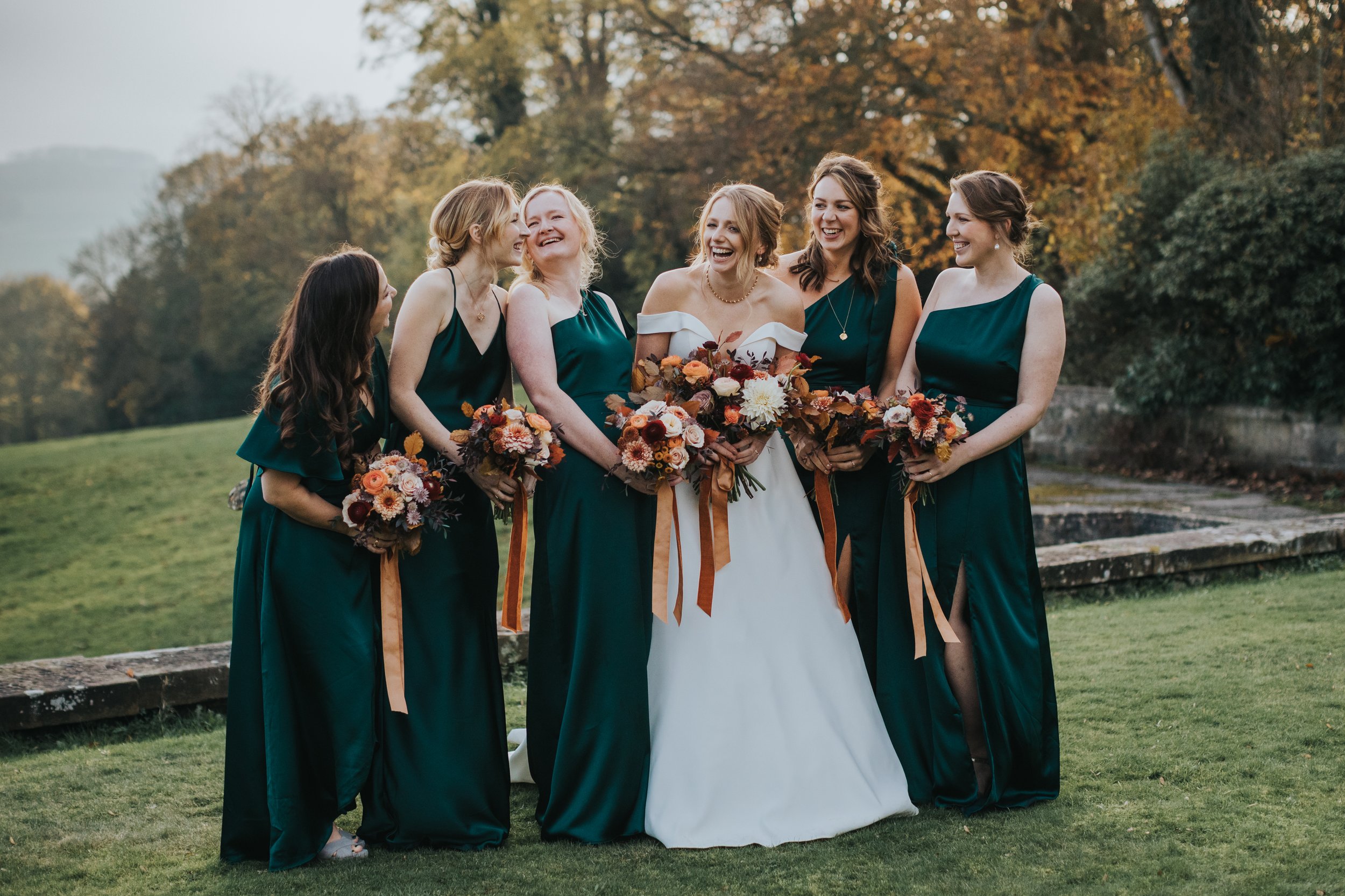 Bride laughing with bridesmaids