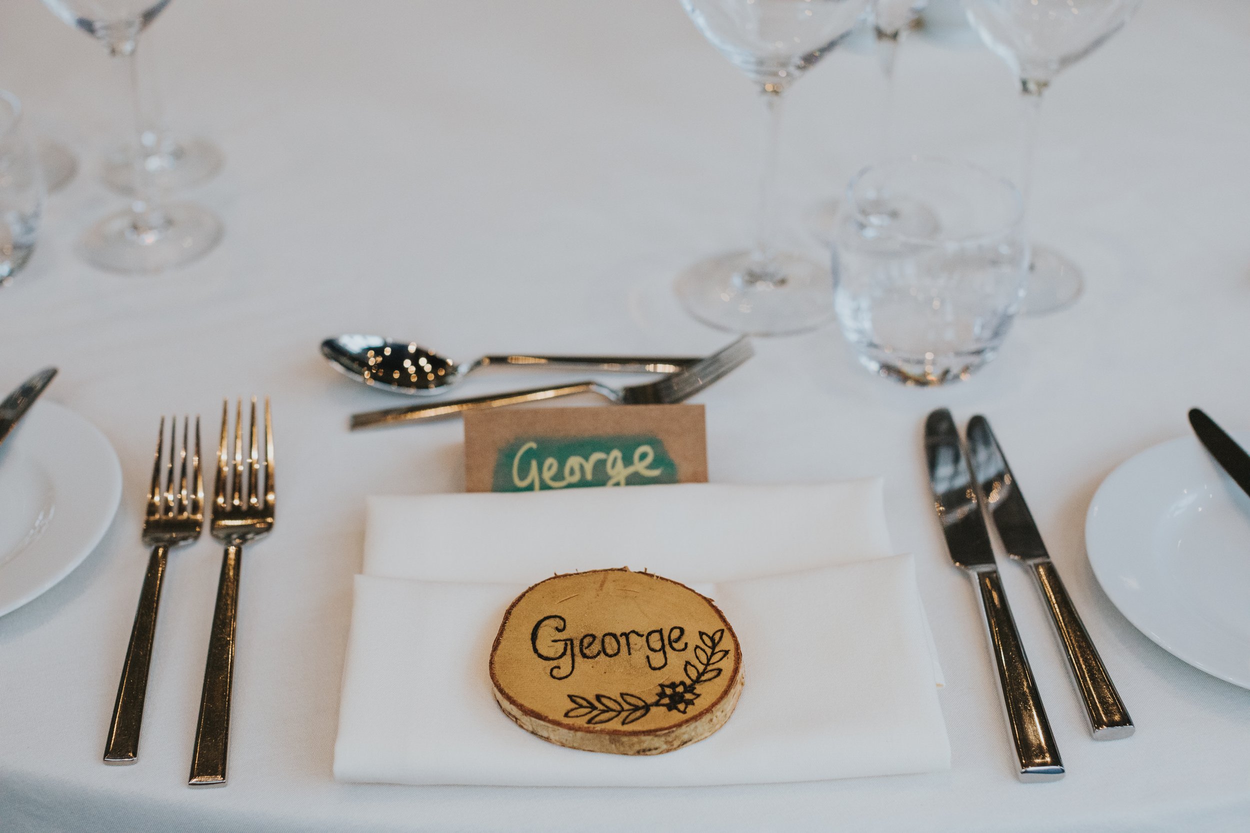 Hand engraved grooms name on wooden disk. 