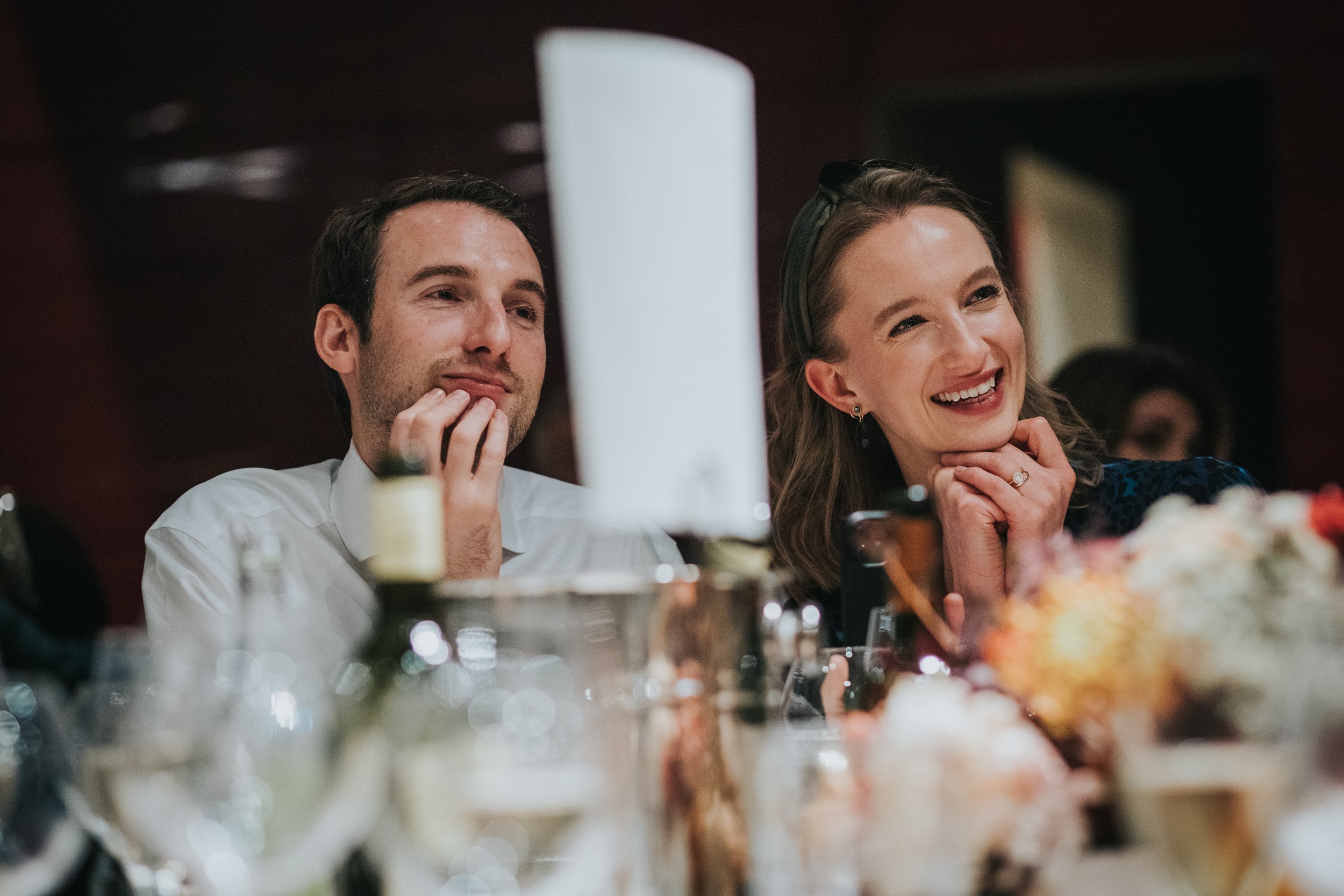 Wedding guest laughing while listening to Mother of the brides speech. 