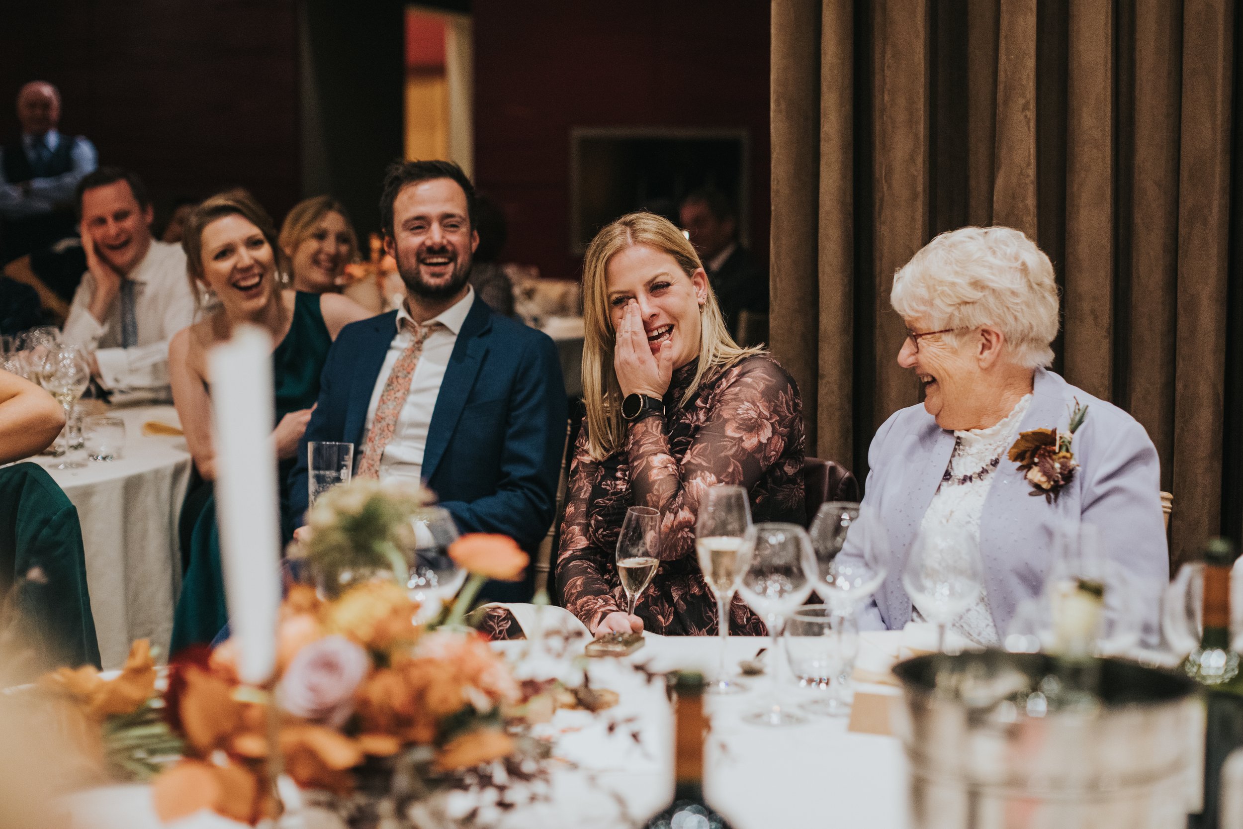 Sister of the groom cries laughing. 