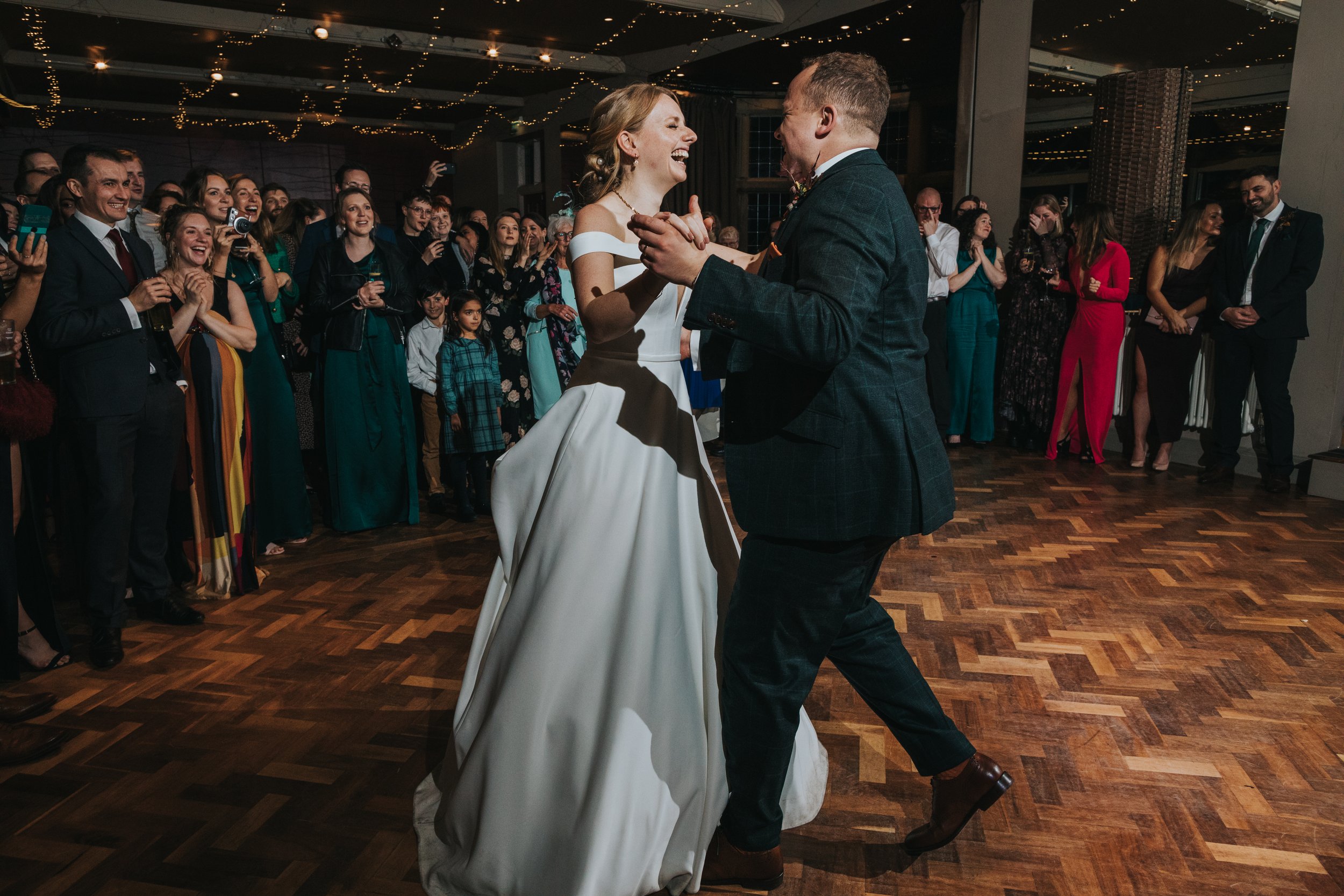 Bride laughs during her first dance. 