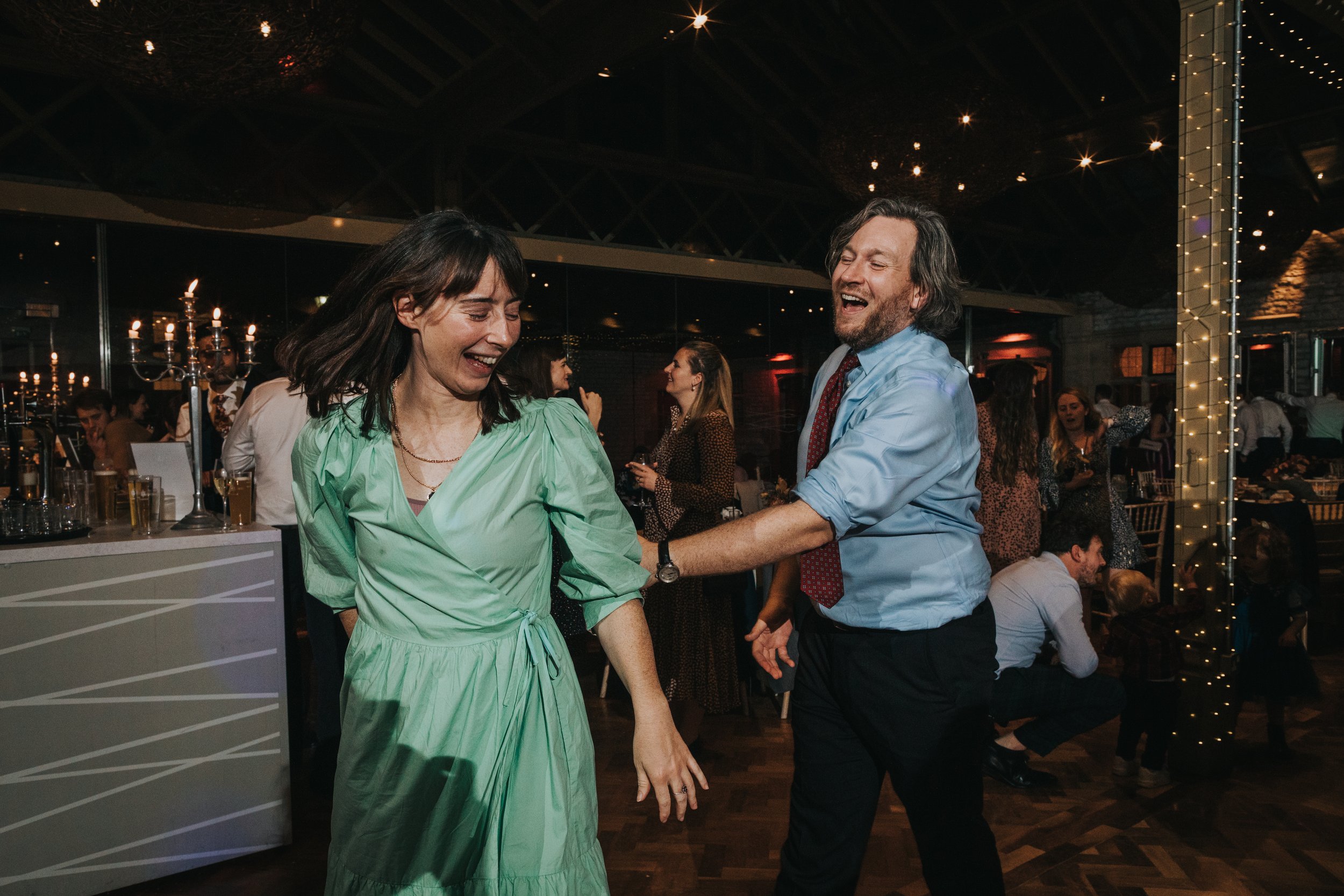 Couple chasing each other across dance floor. 