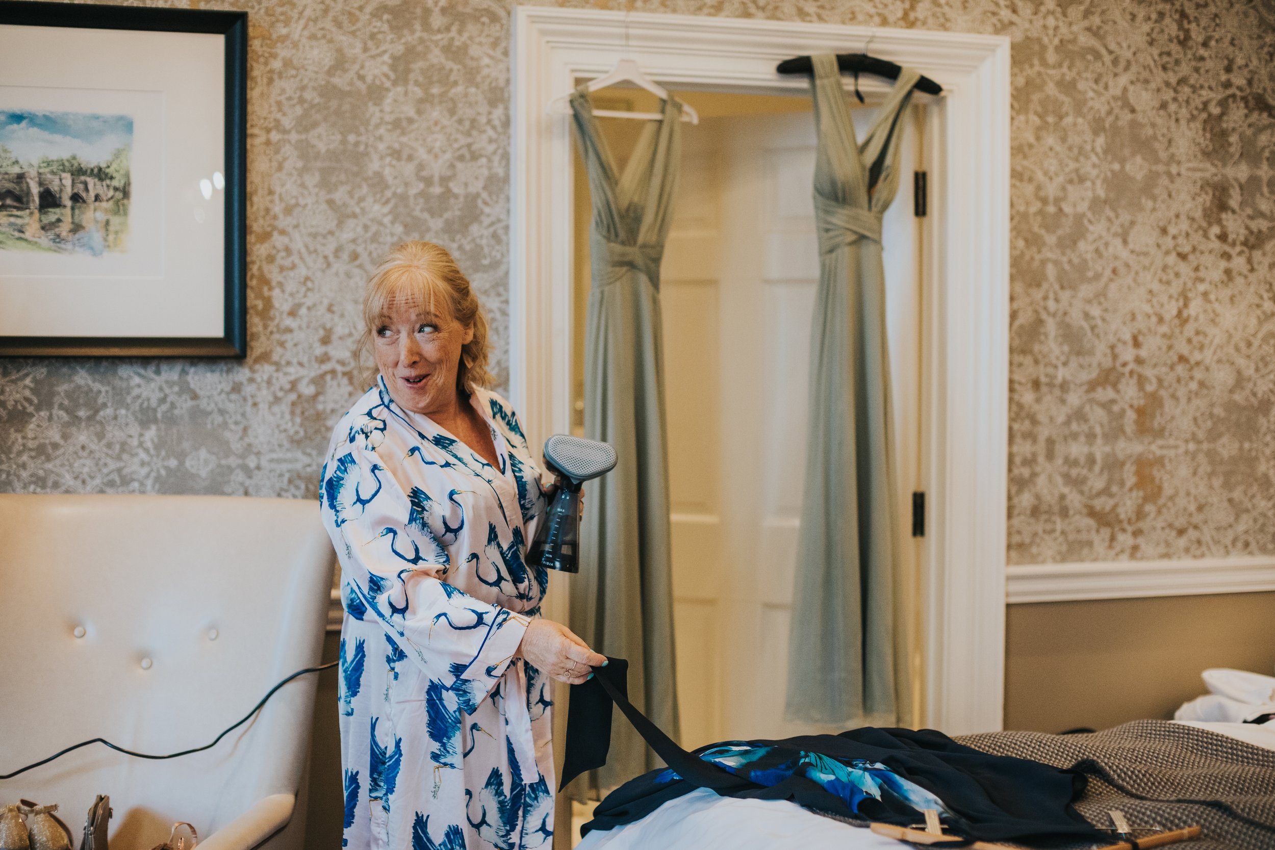 Mother of the bride steaming the bridesmaid dresses on the morning of the wedding