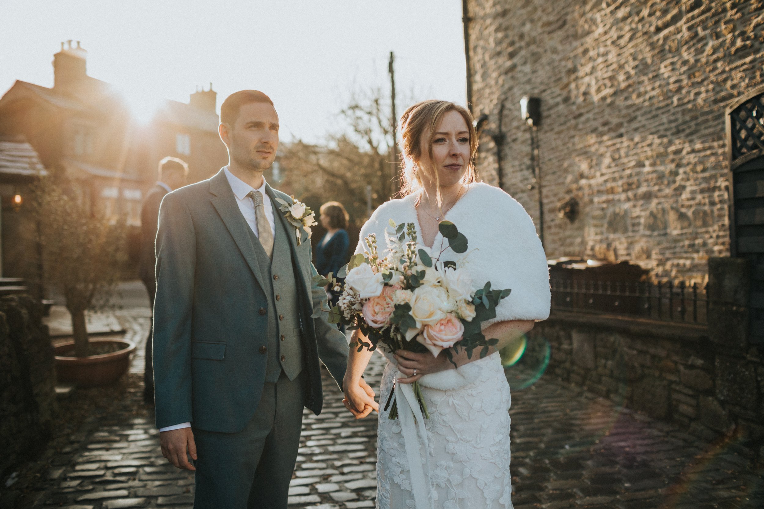 Bride and Groom looking cool on a cobbled street in Chinley. 