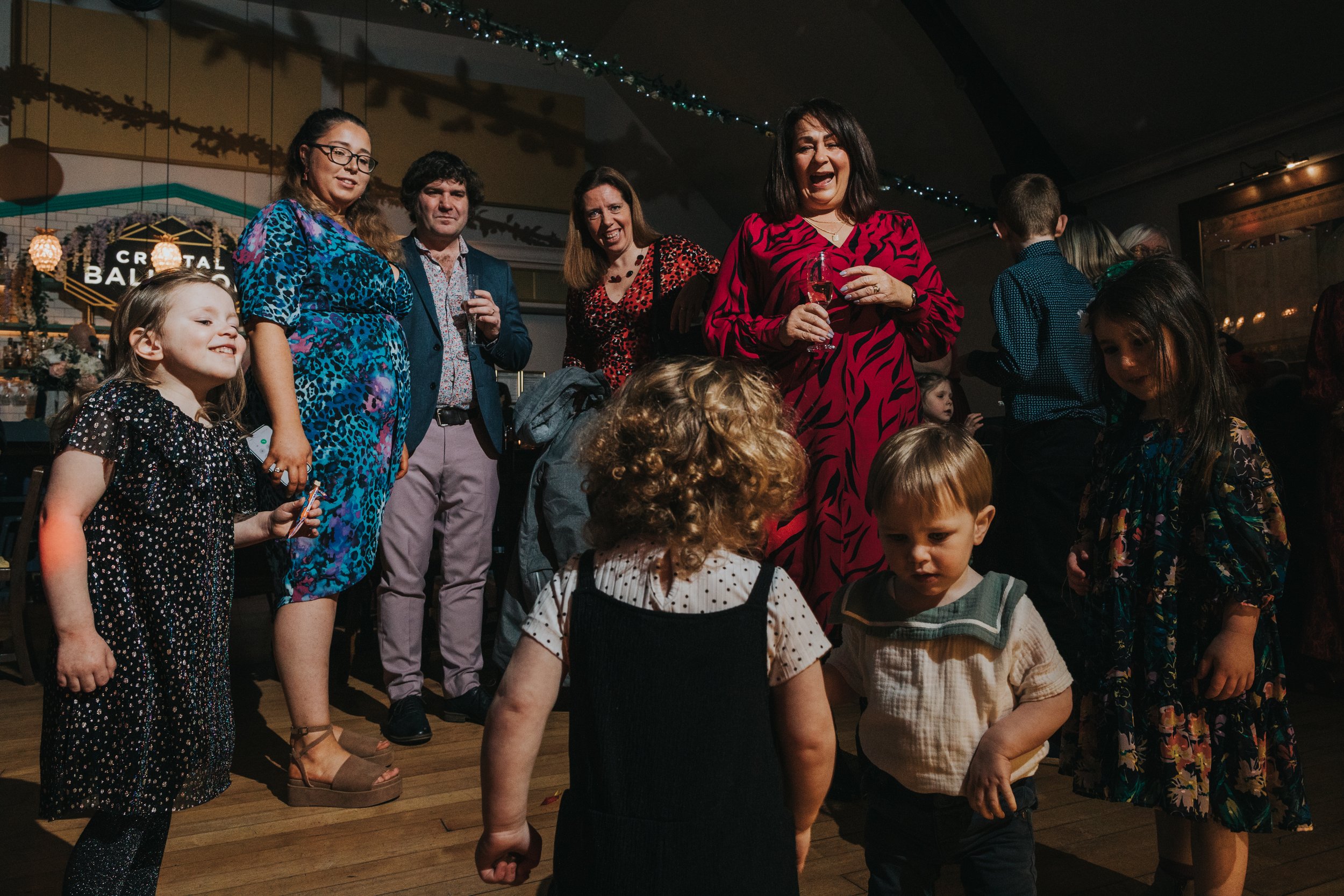 Wedding guests watch children dancing. 