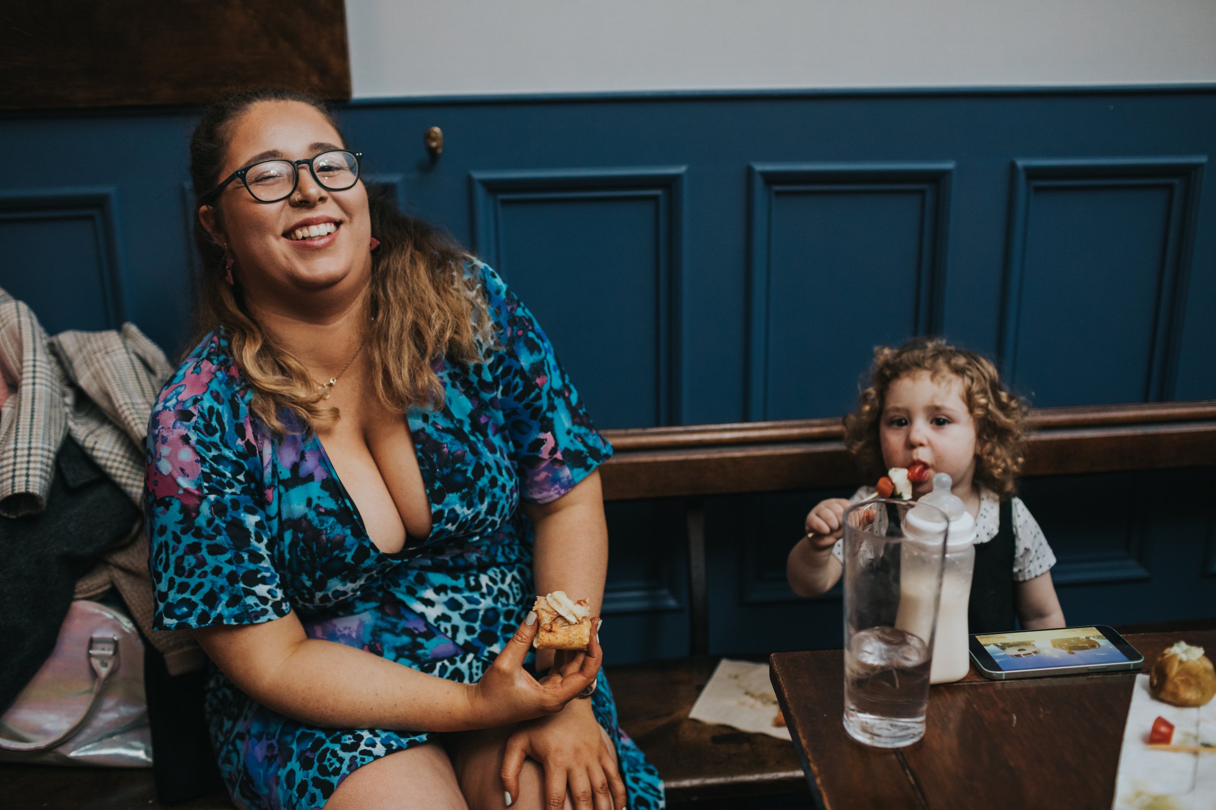 Mother and child enjoy some wedding reception snacks. 