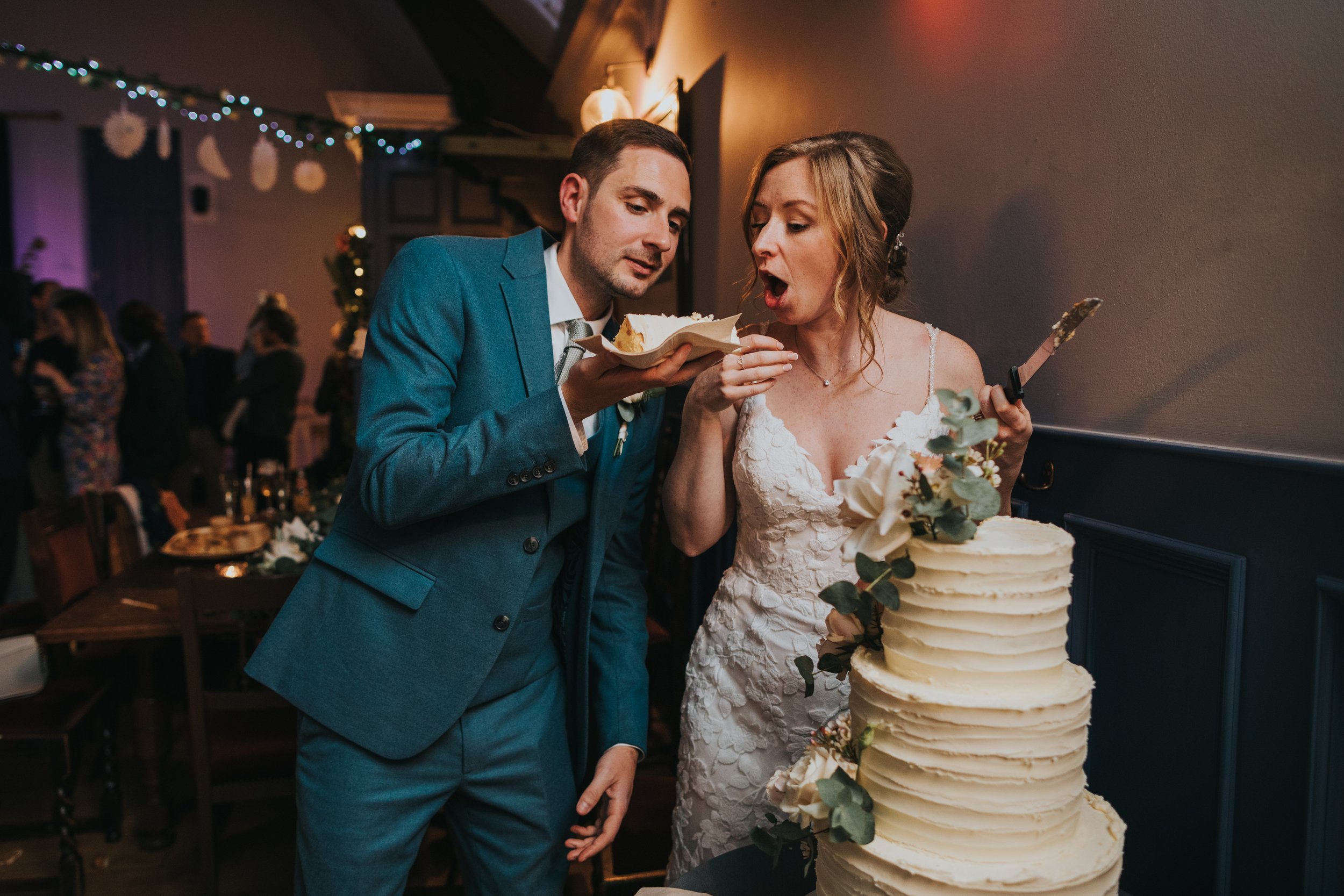 Couple enjoy wedding cake.