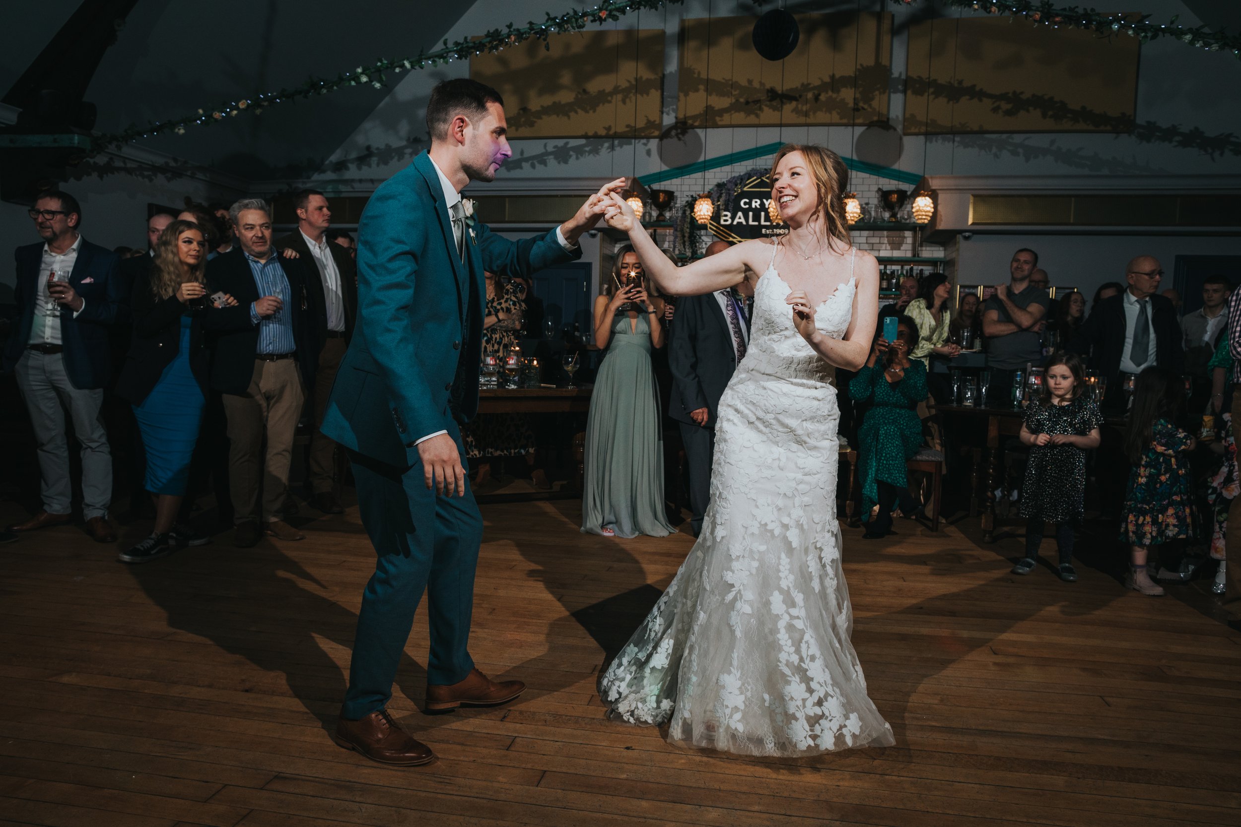 Bride laughing as she dances with her husband at the Crystal Ballroom, Glossop, Derbyshire.