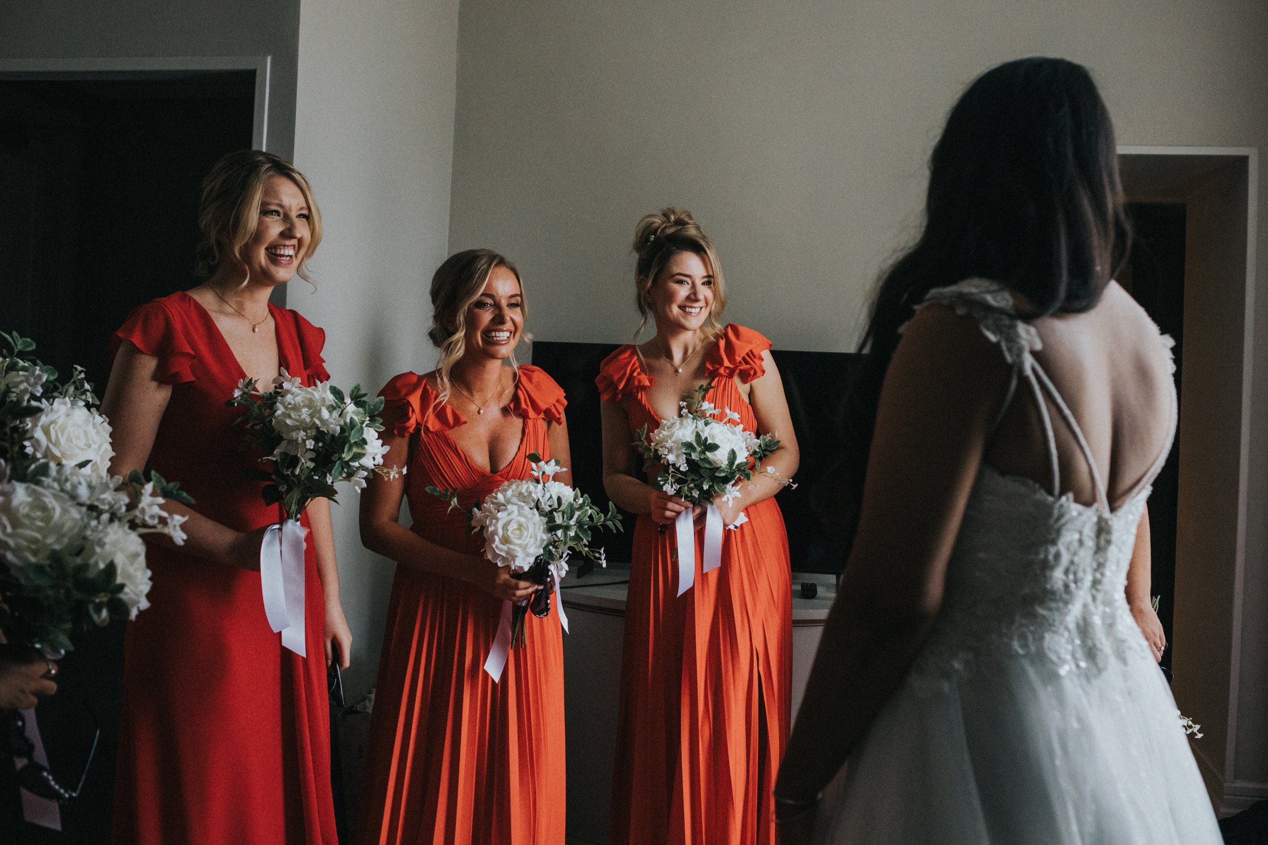 Bridesmaids arrive to see Bride in her wedding dress. 