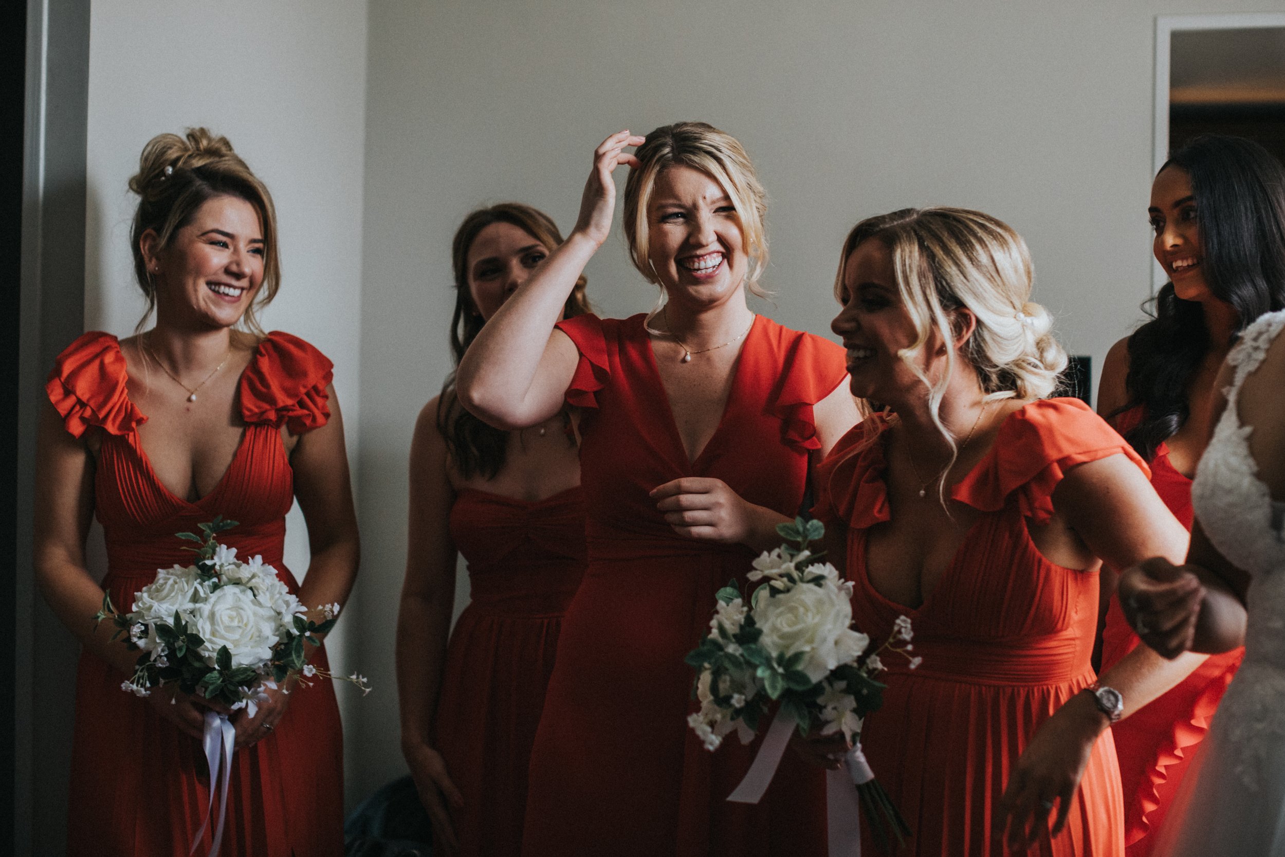 Bridesmaids laughing together. 