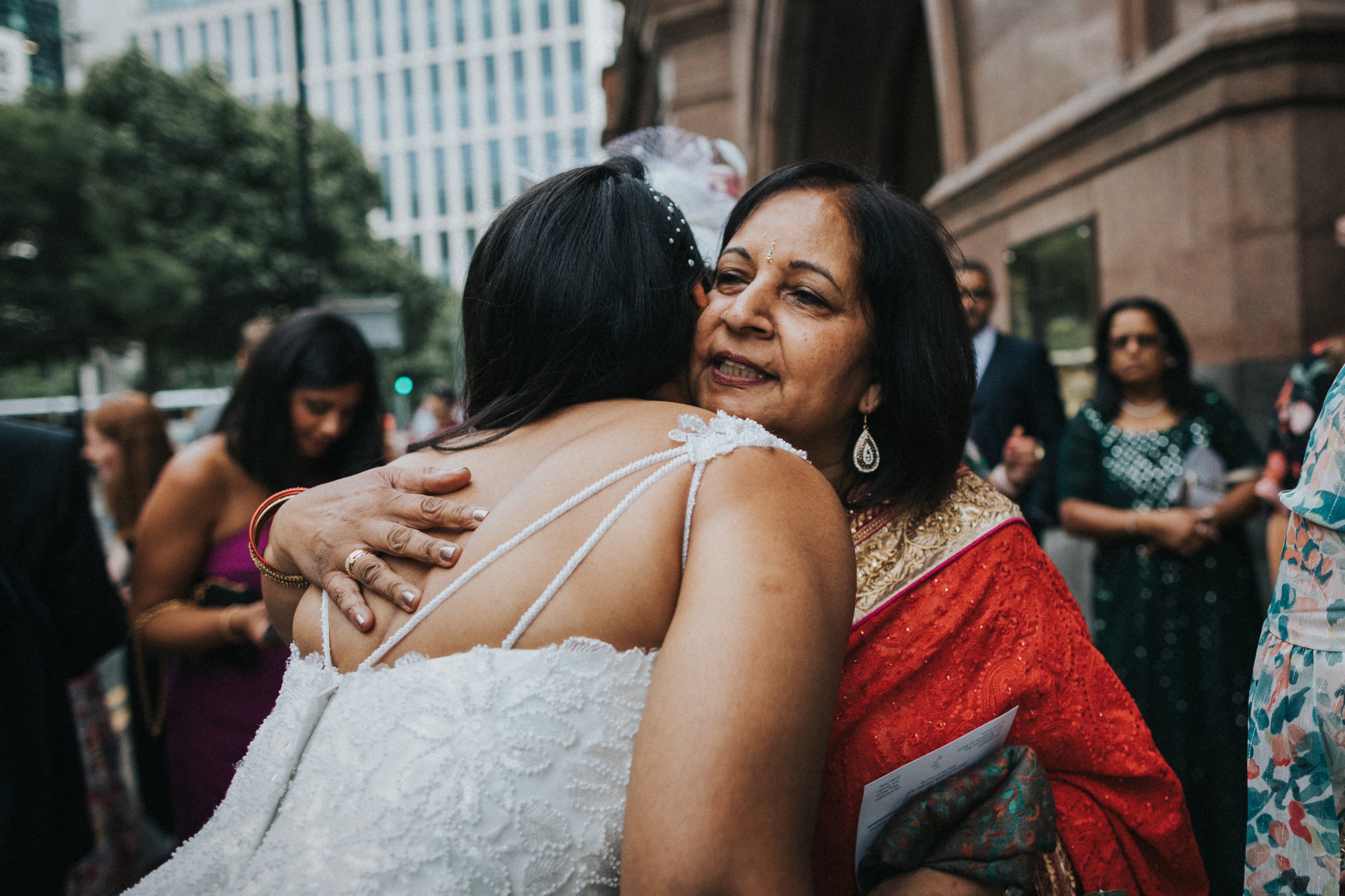 Wedding guest gives Bride a big hug. 