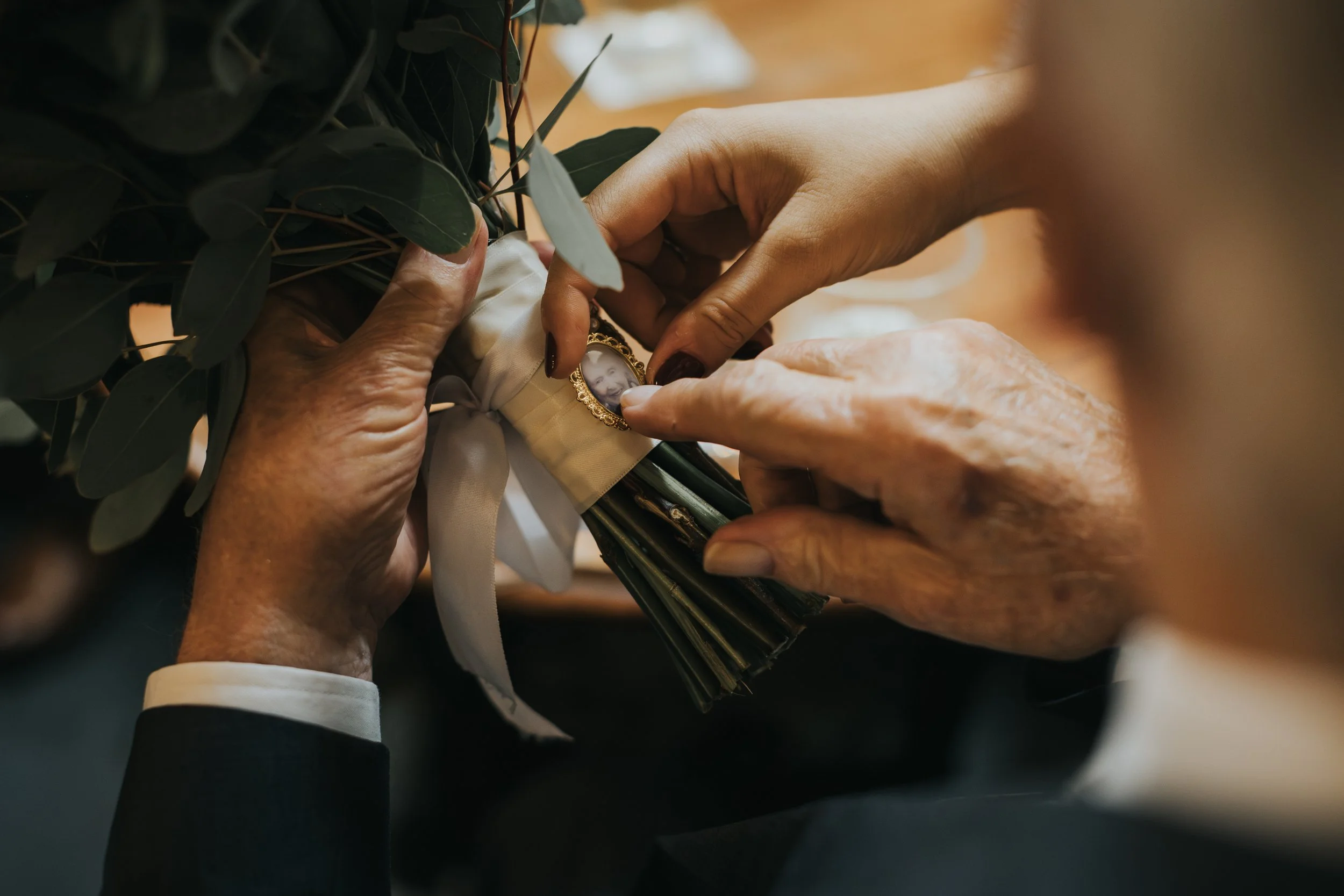 Photograph of brides grandmother attached to flowers