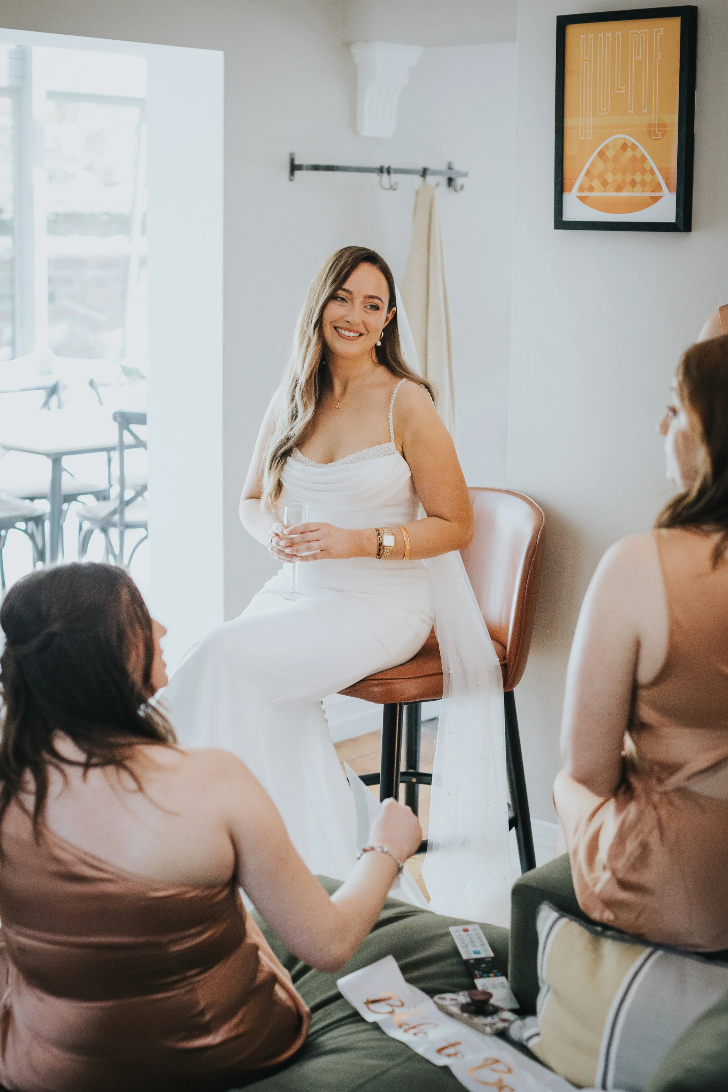 Bride smiling wearing bride to be sash from her hen do