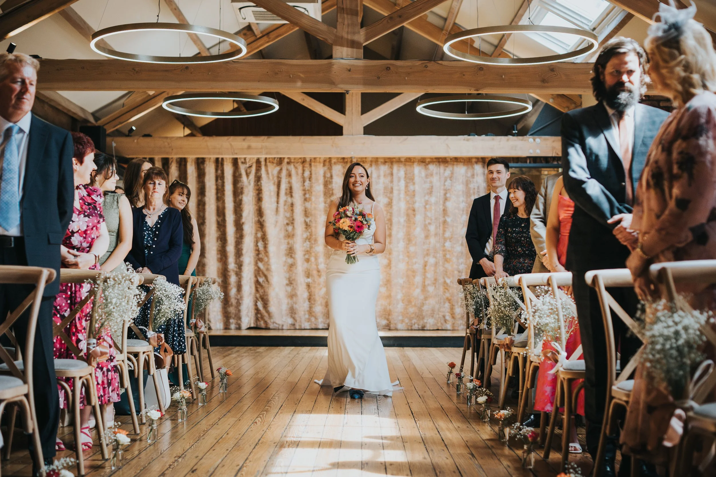 Bride walks down the aisle in the Castlefield Rooms Manchester