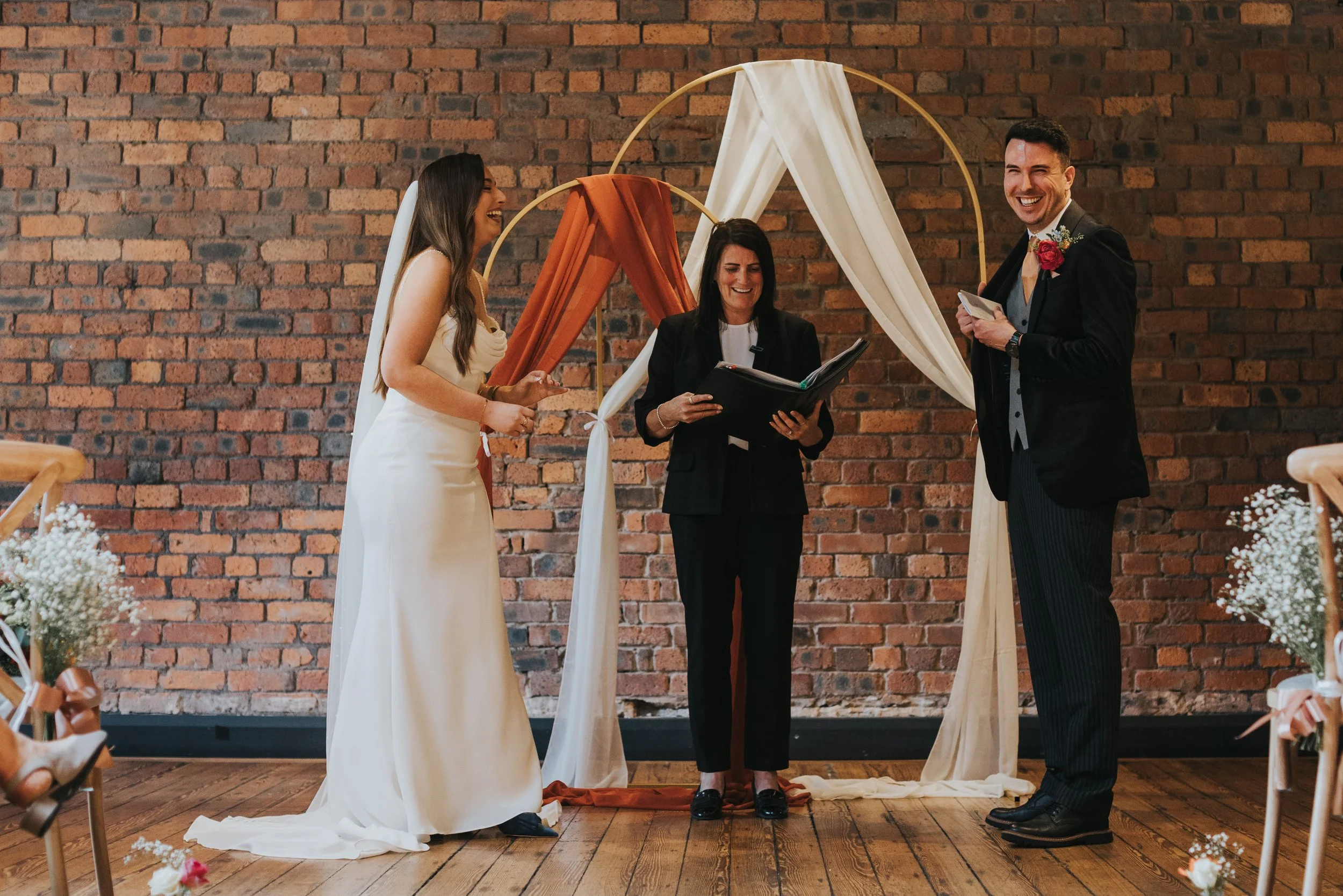 Bride and Groom laugh as they read their vows. 