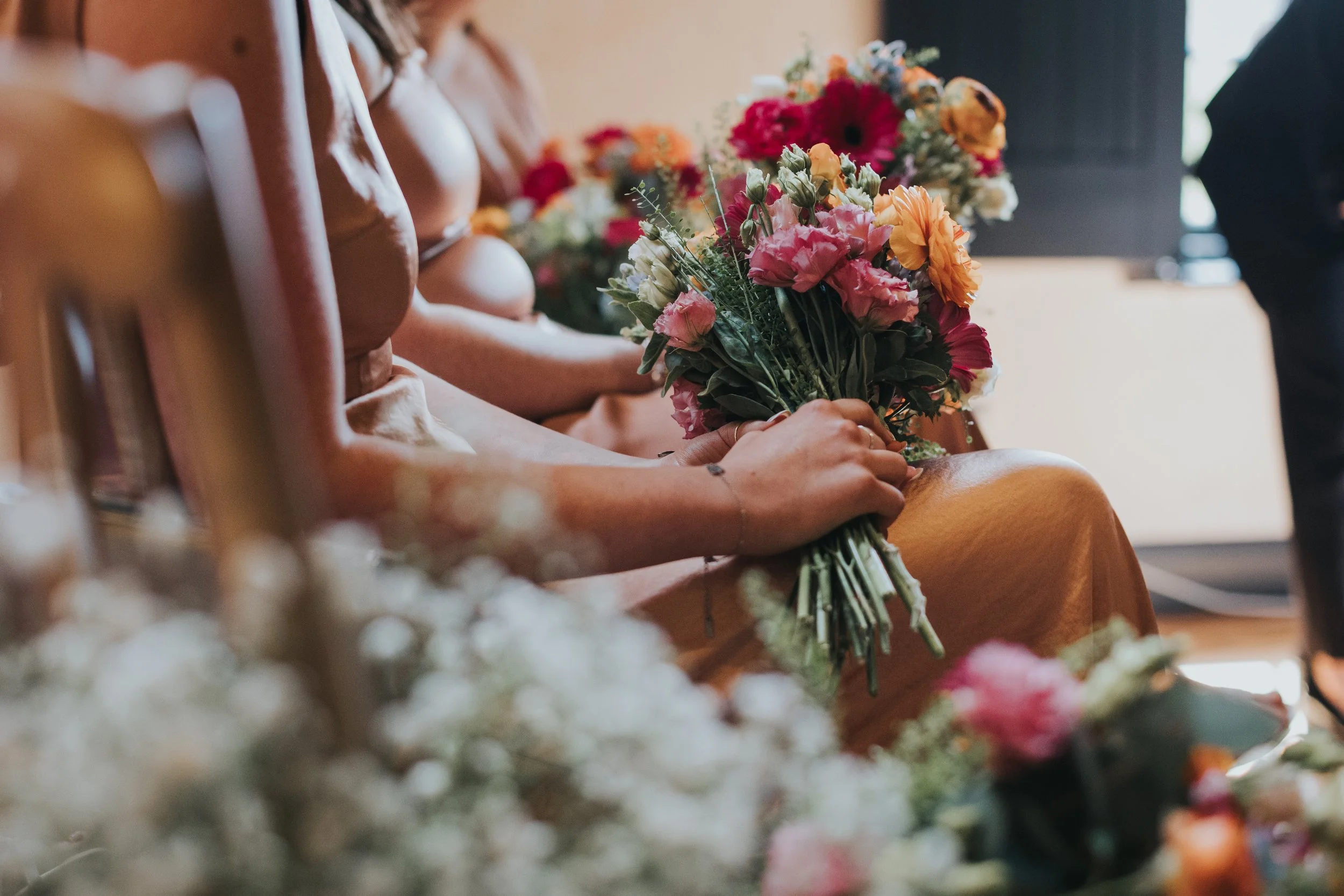 Bridesmaids holding flowers. 