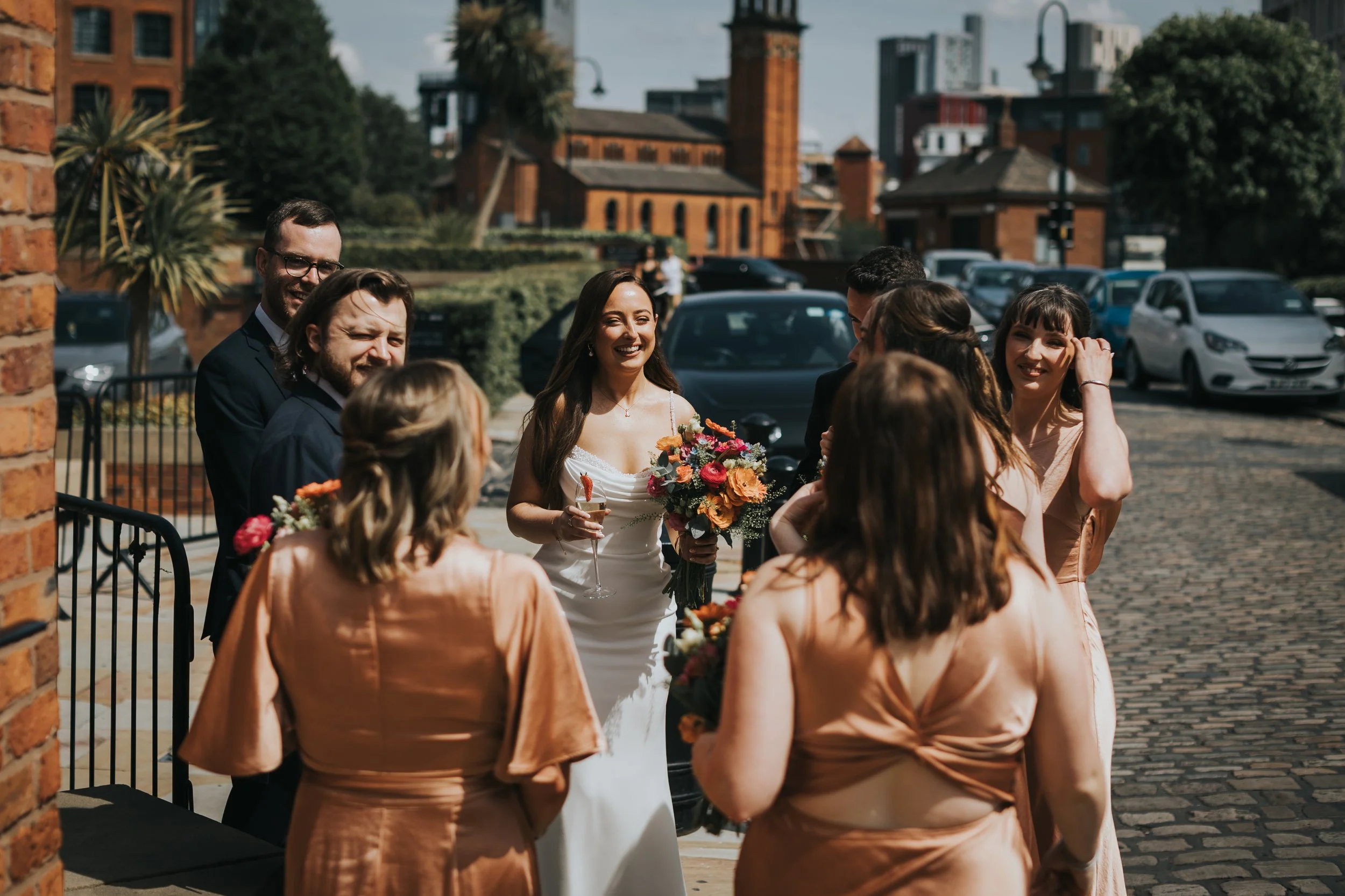 Bride greets her guests outside. 