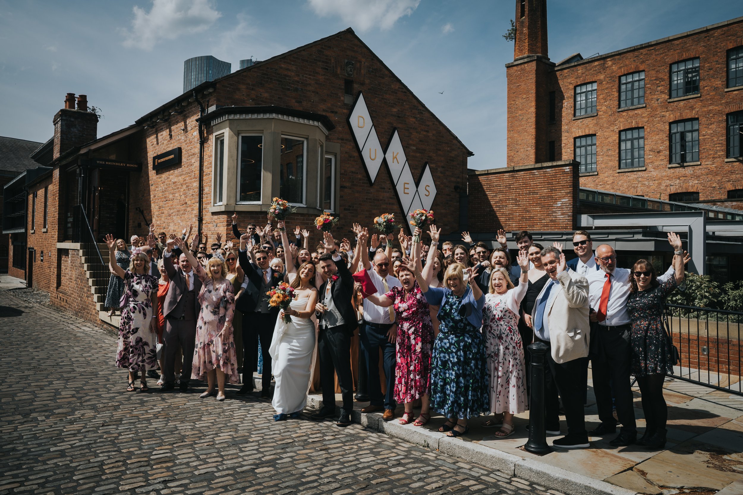 Group Photo of Wedding Guests Outside Castlefield Rooms. 