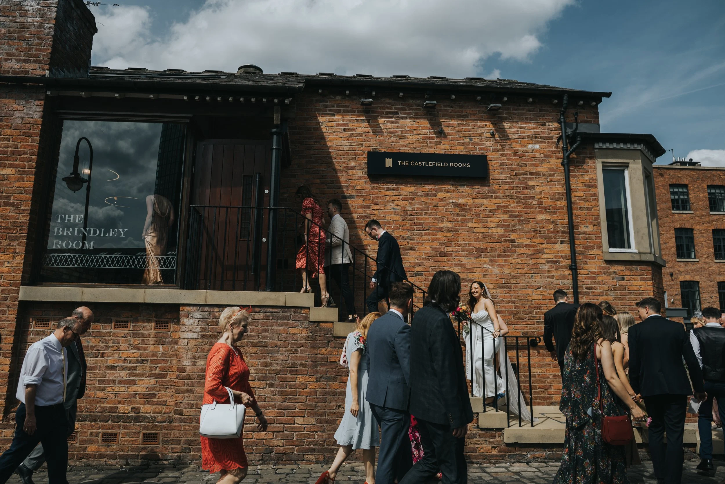 Bride going up steps into Castlefield rooms. 