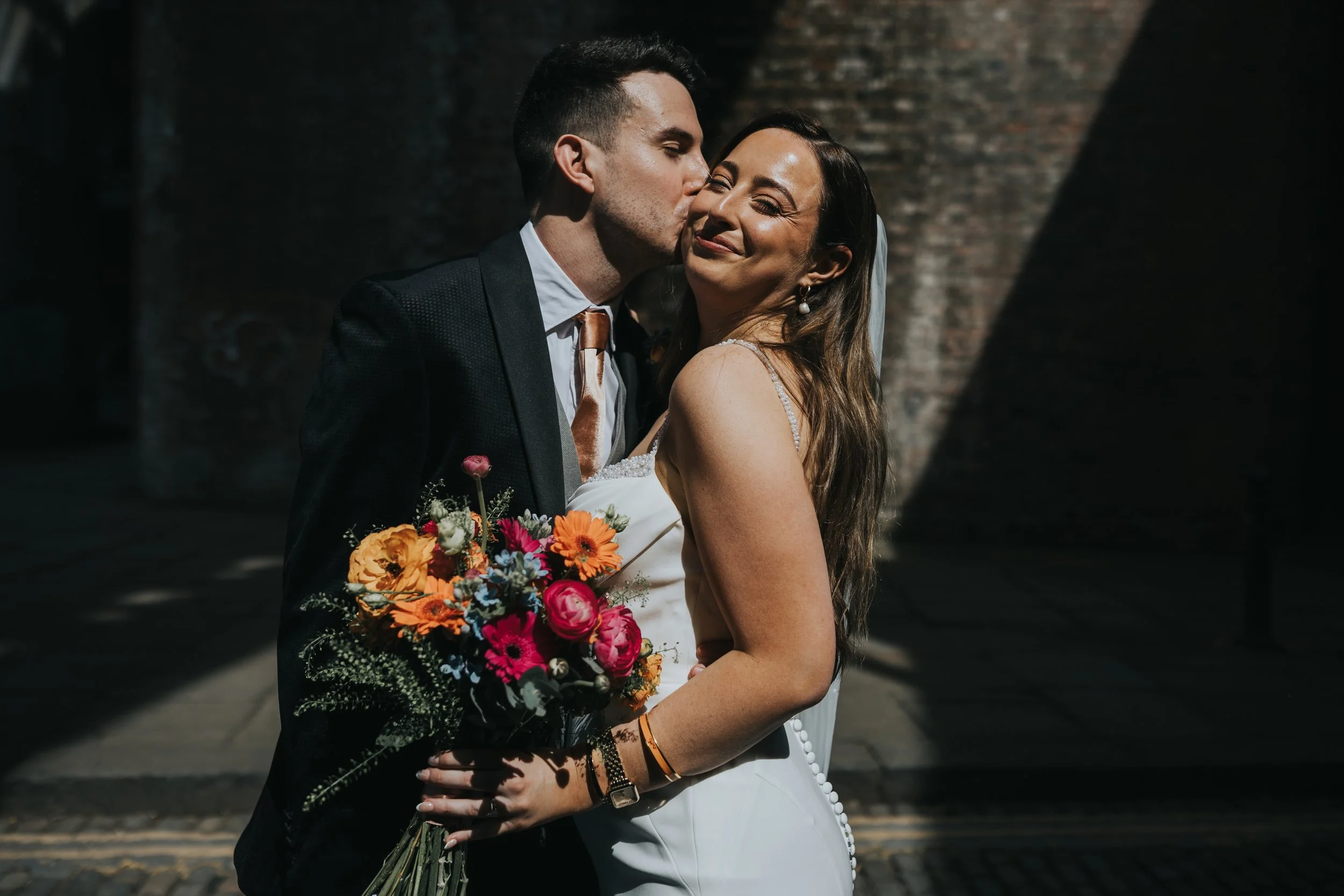 Groom kisses his bride. 