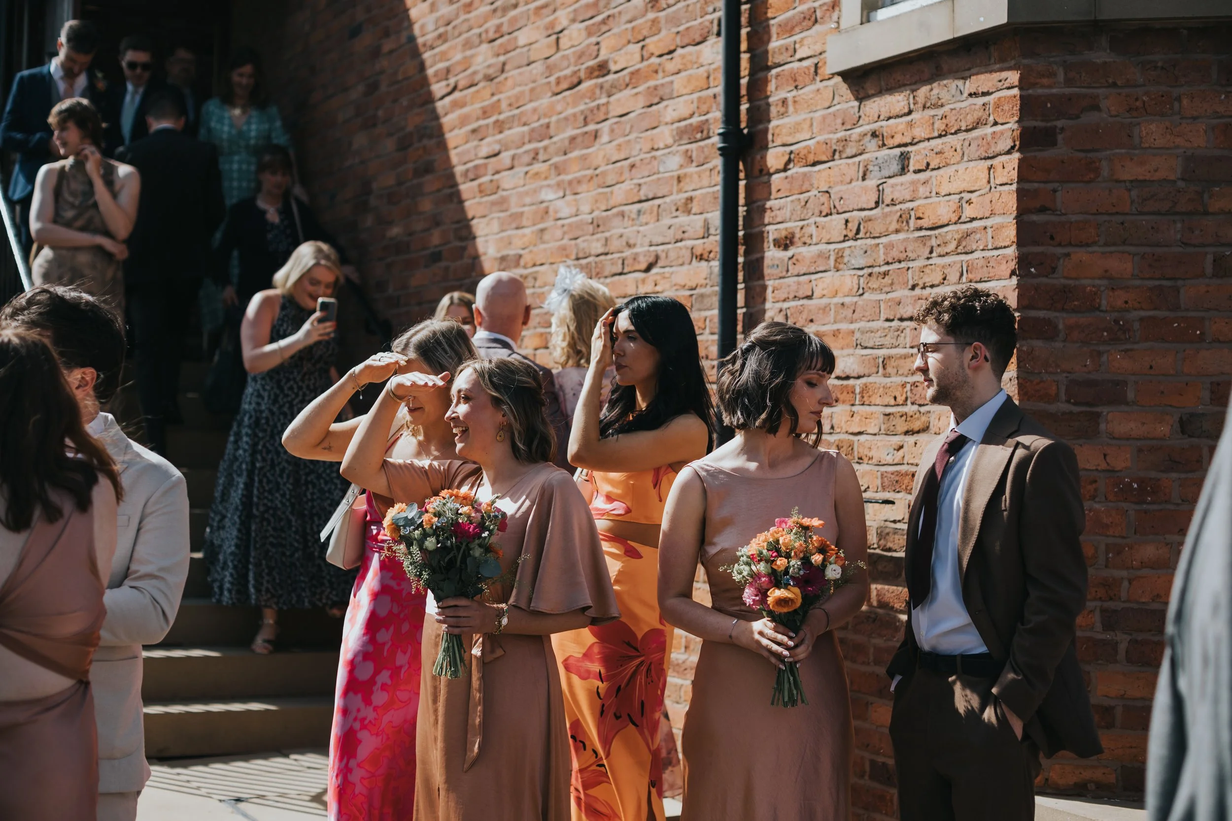 Guests look out for bride and groom to welcome them. 