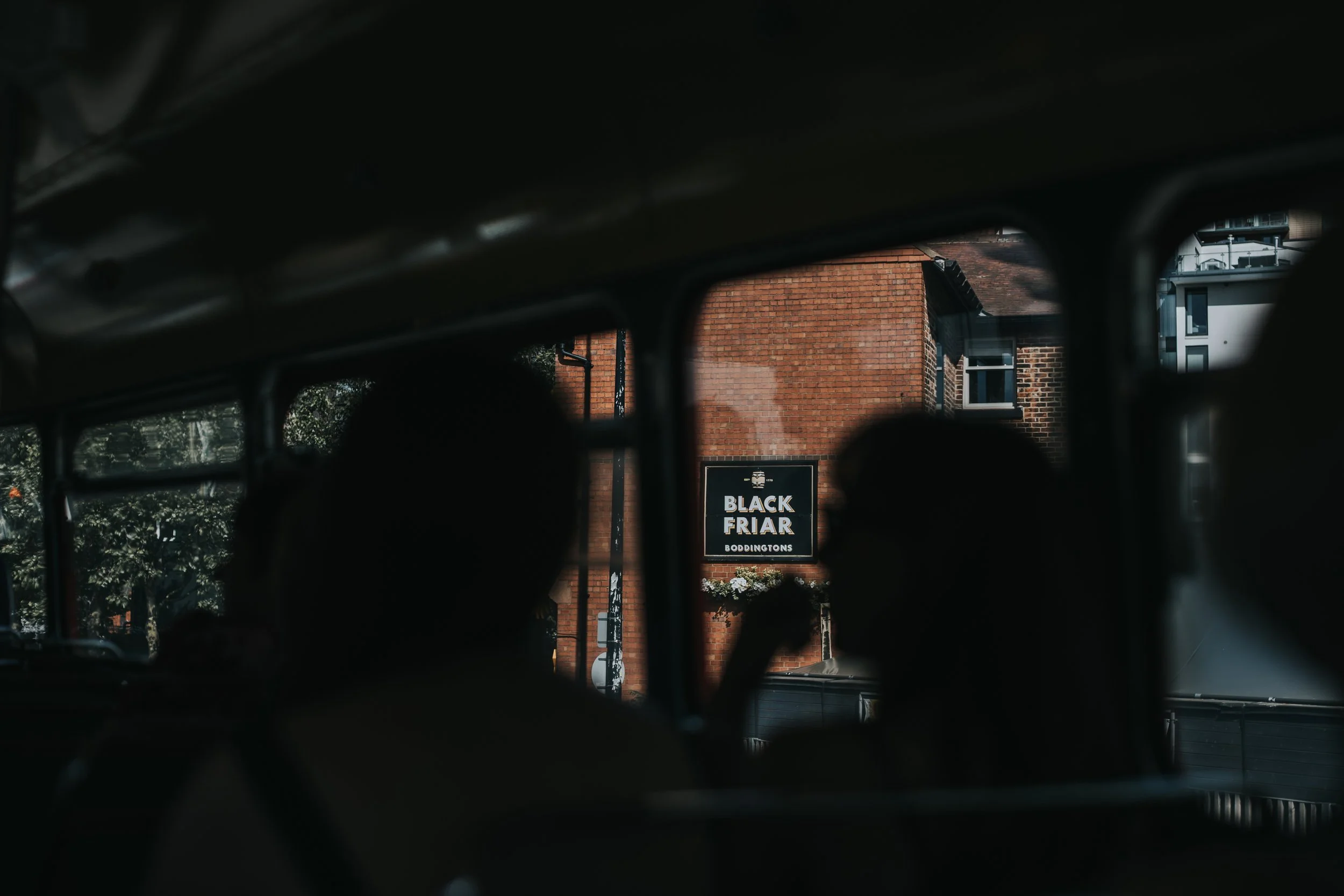 Black Friars sign through the window of the bus. 
