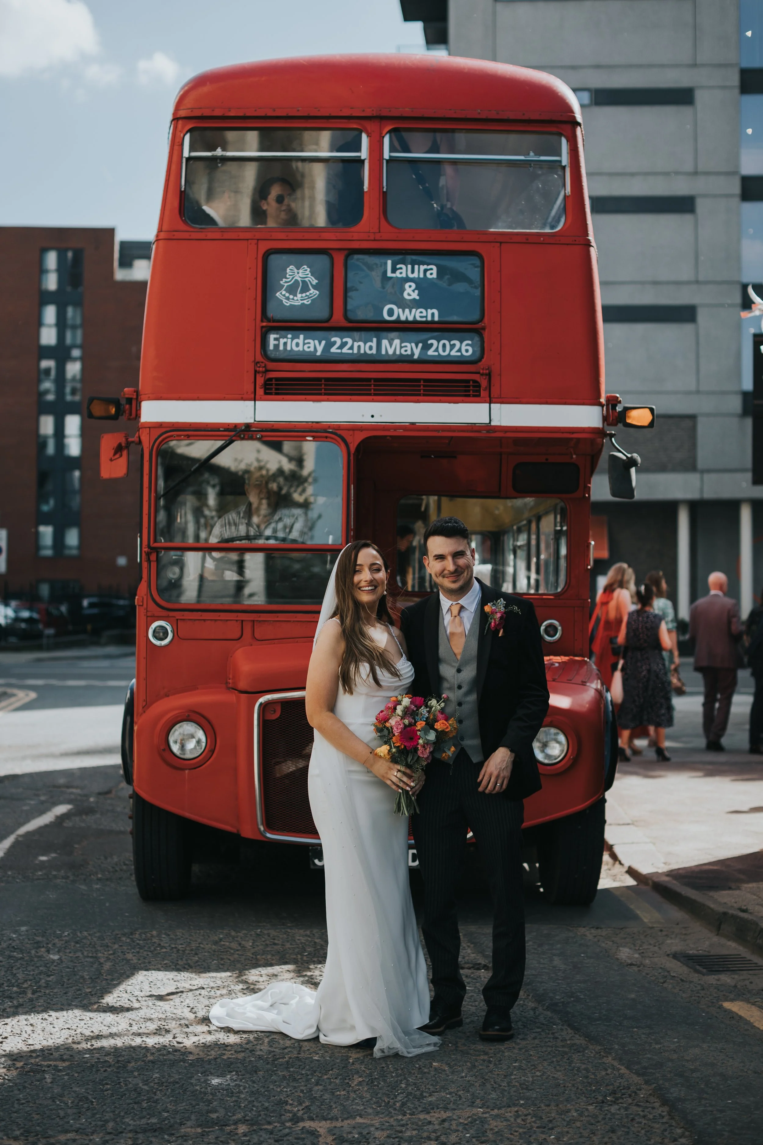 Bride and Groom in front of bus. 