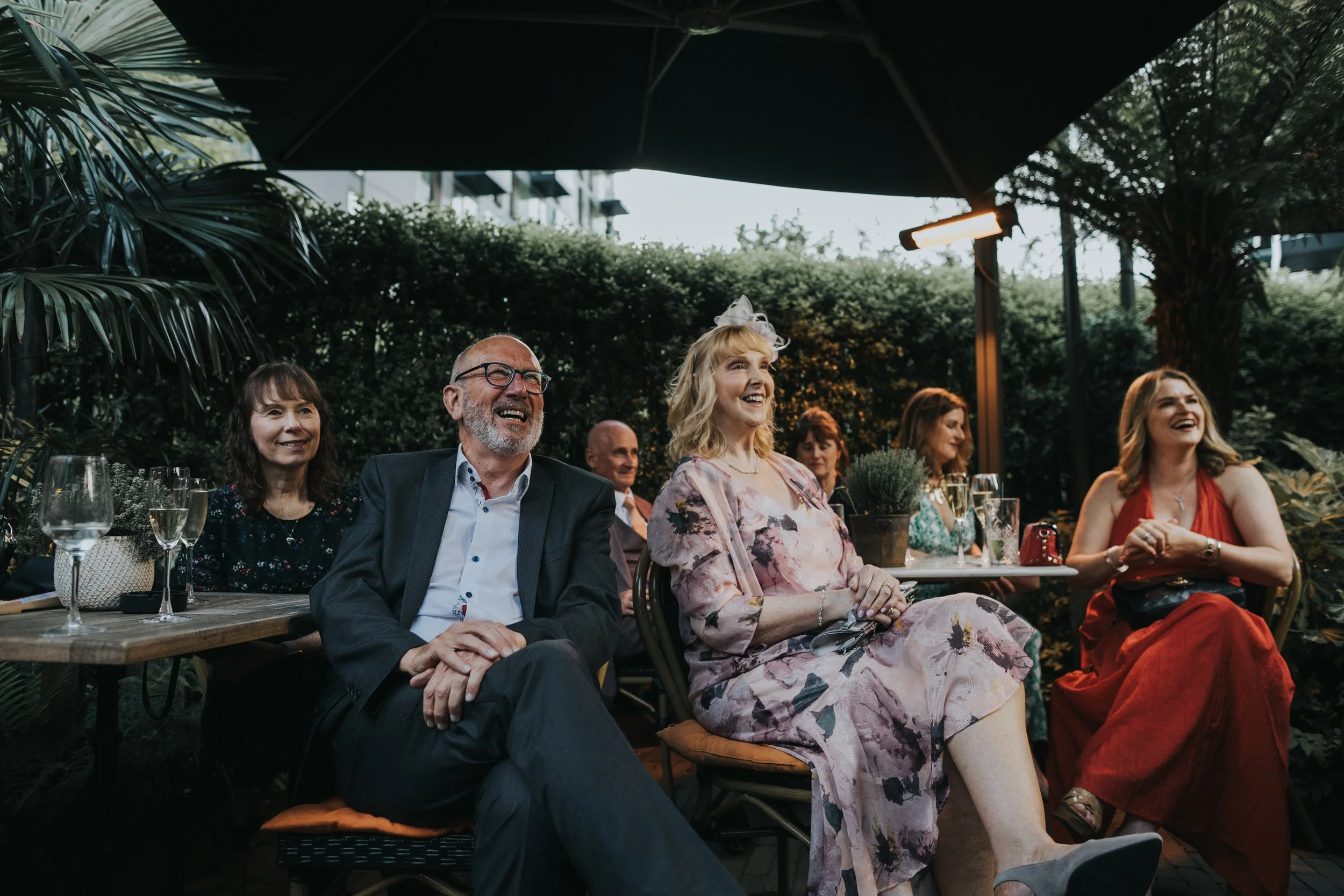 Mother of the bride laughing at speech. 