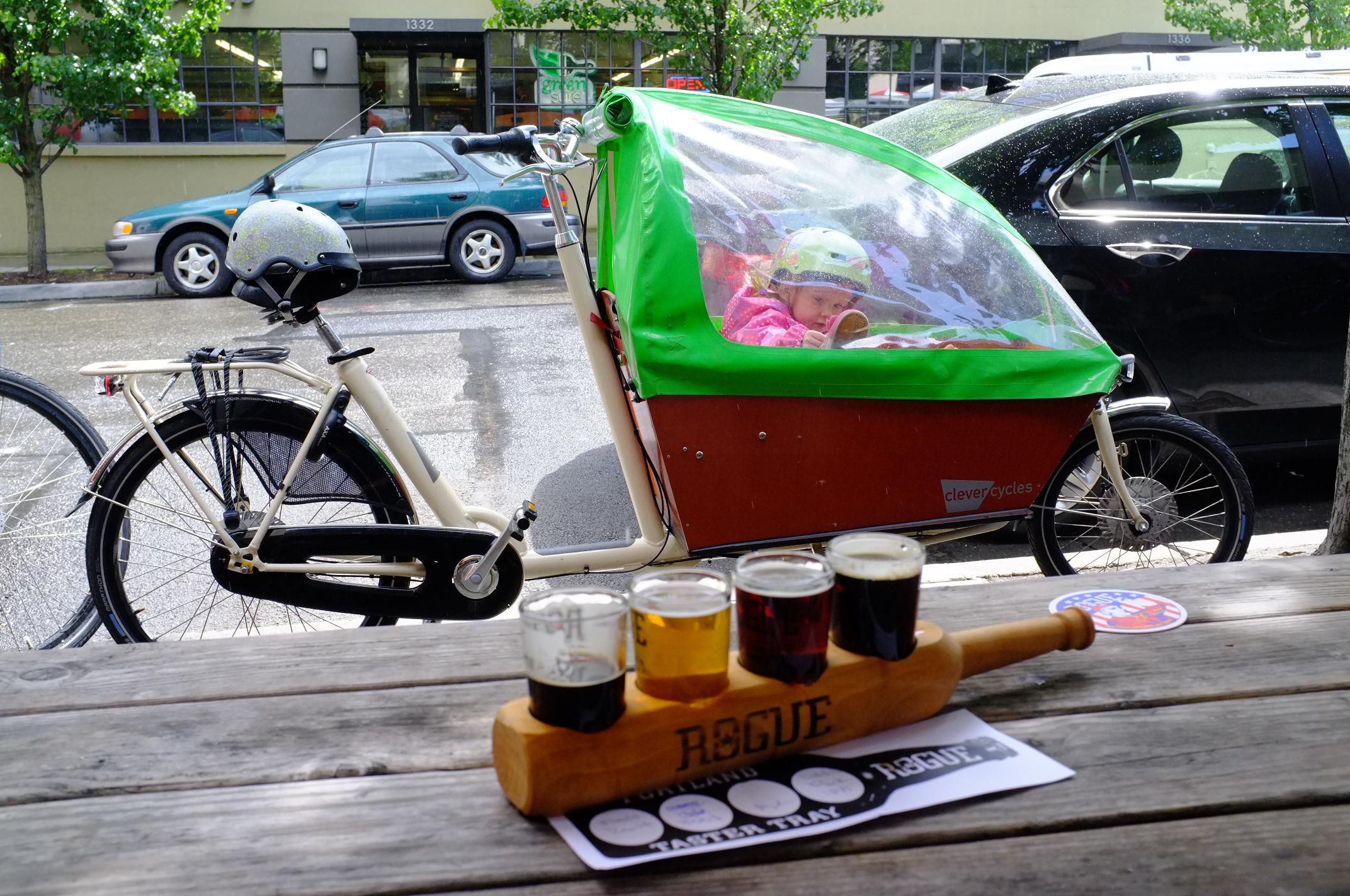 Kids stay dry in Portland mist with a Bakfiets rental from Clever Cycles